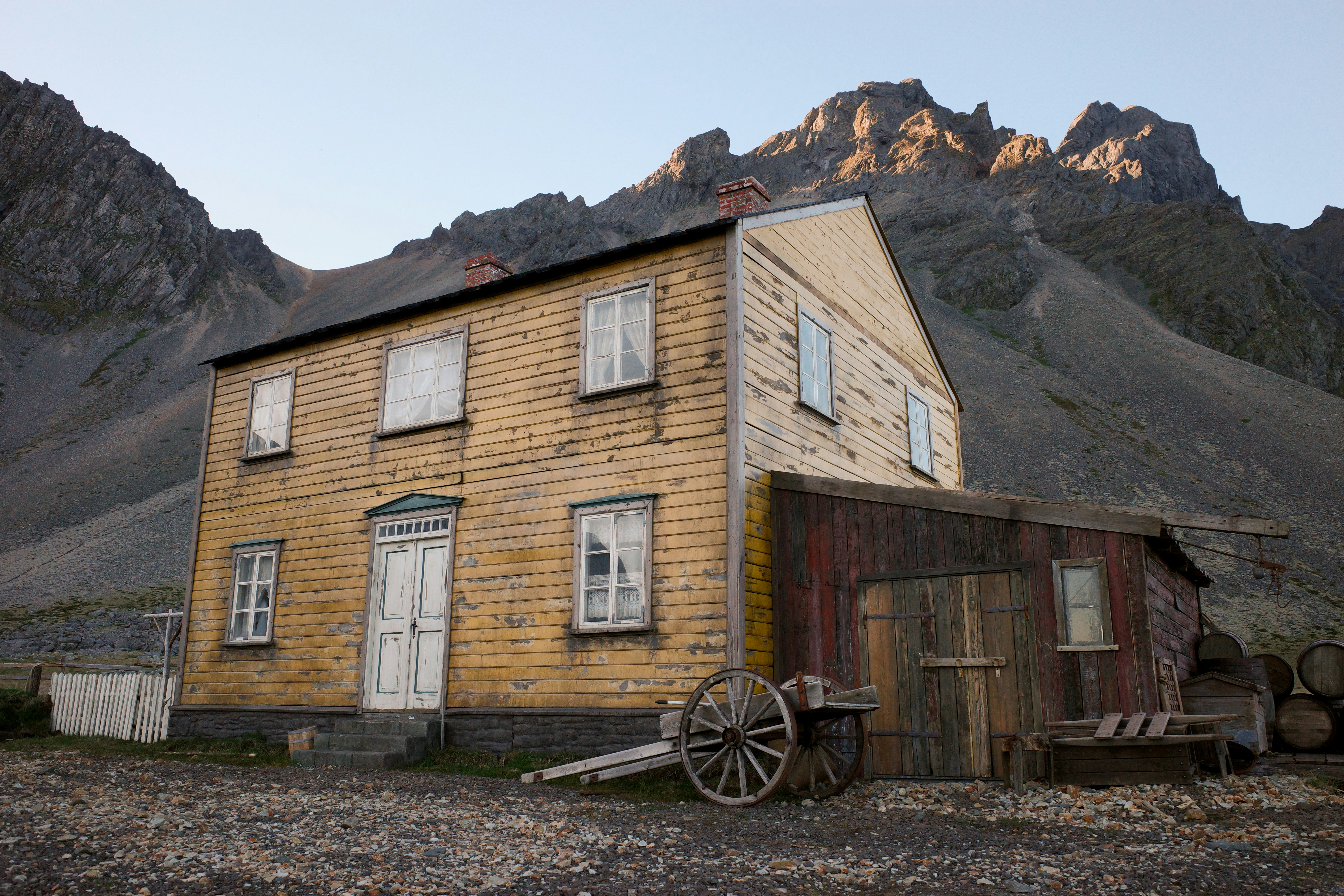 Old wooden house with mountains in the background
