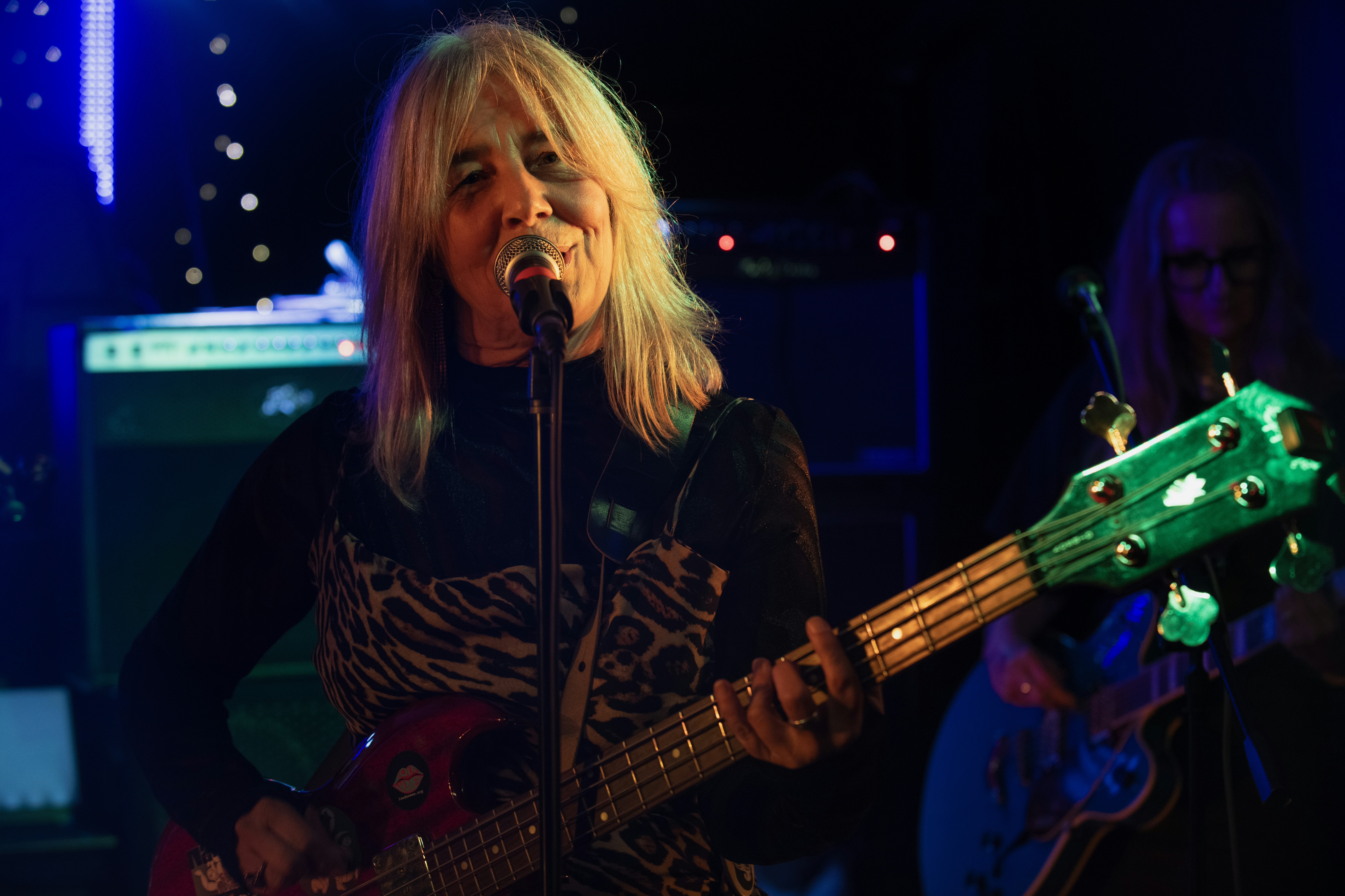 Woman playing guitar and singing on stage