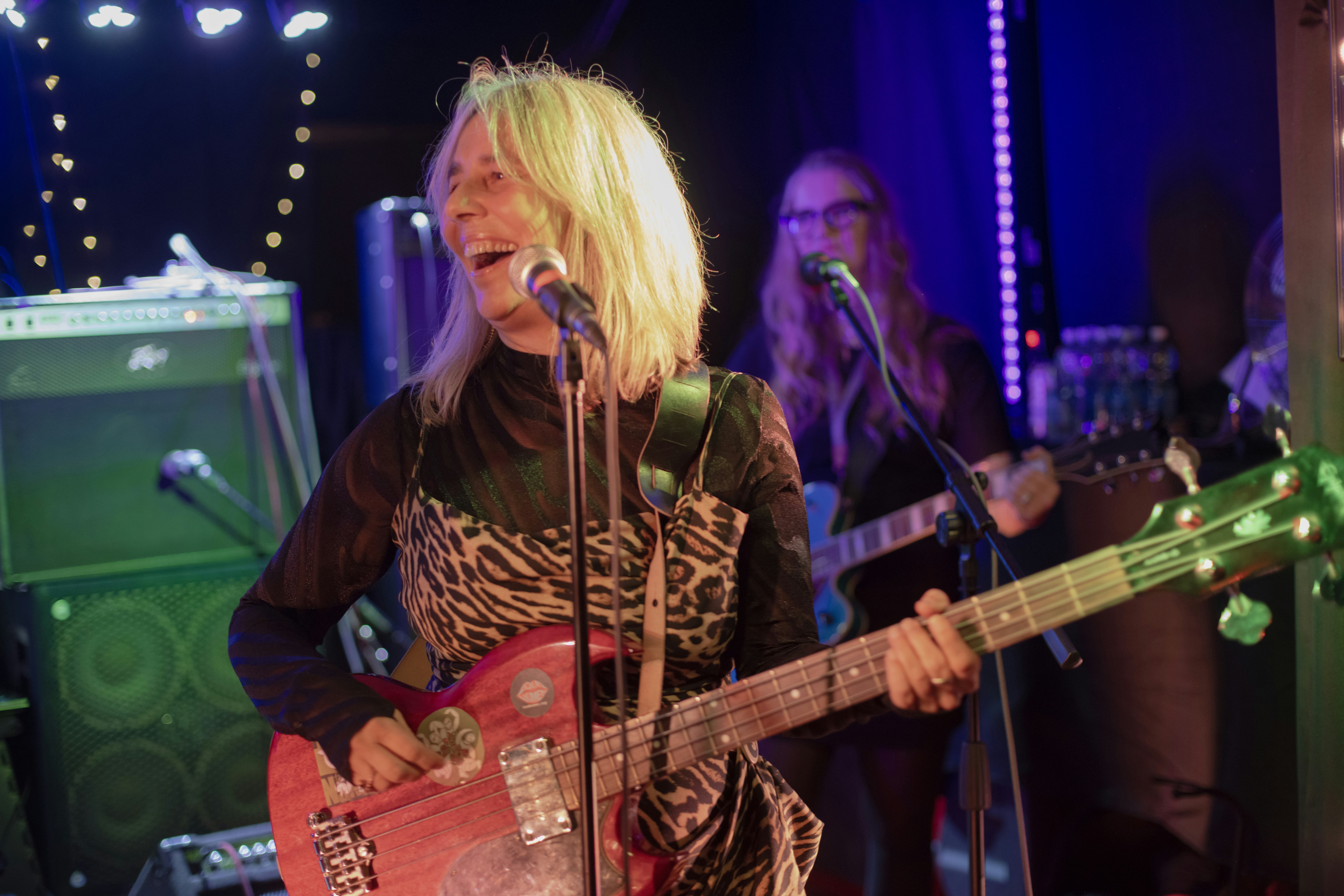 Woman singing and playing guitar on stage