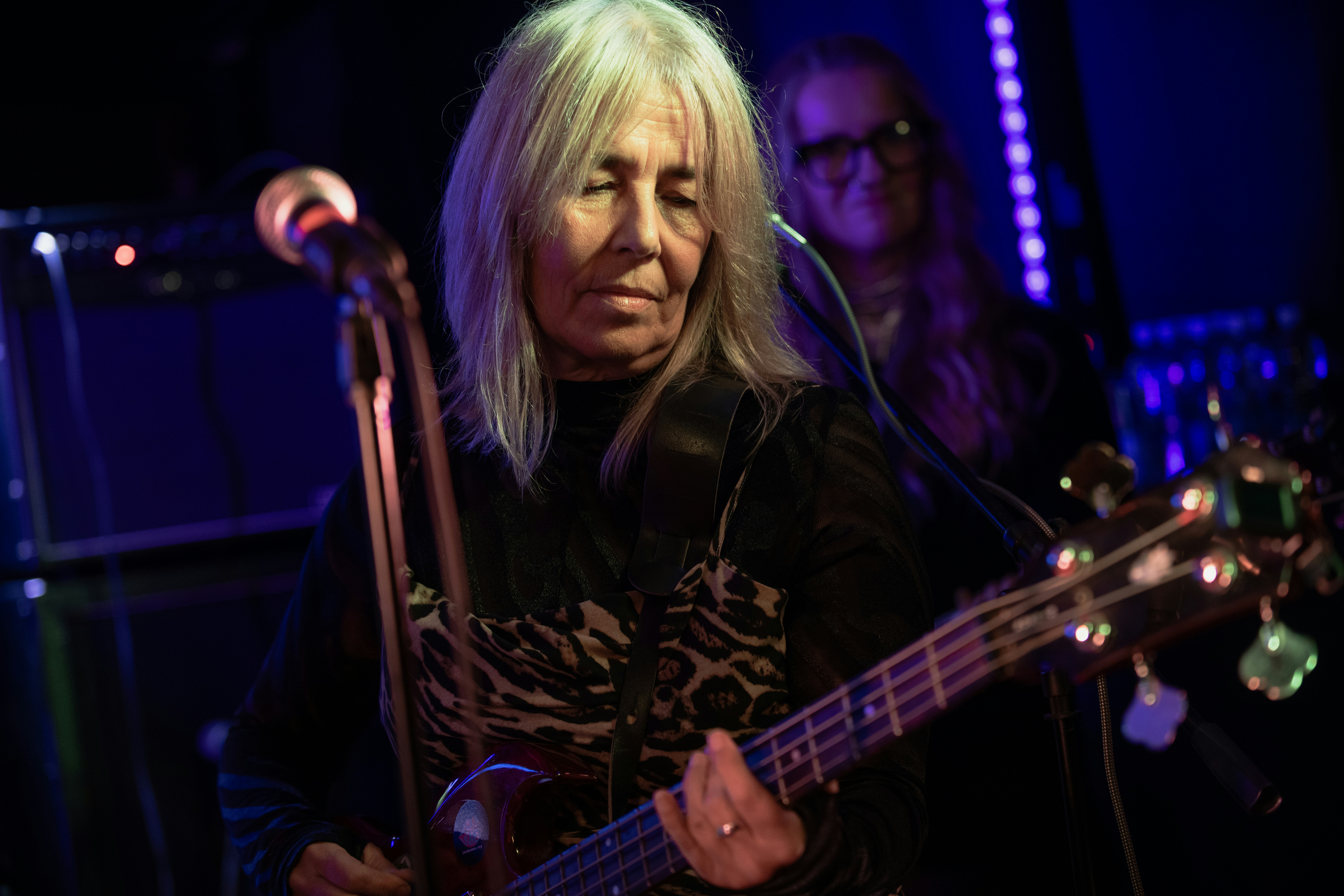 Woman playing a bass guitar on stage