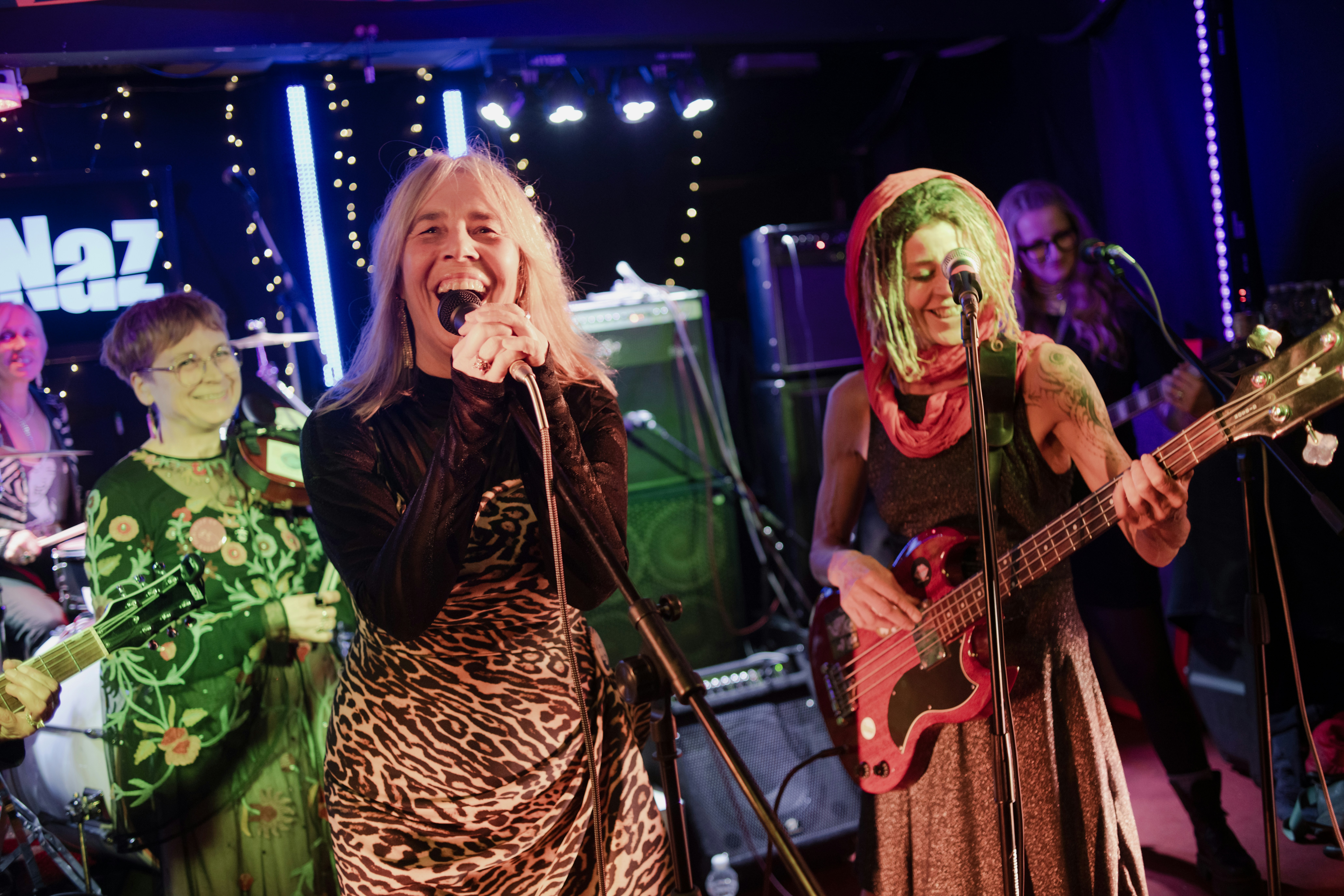 Women performing music on stage with instruments