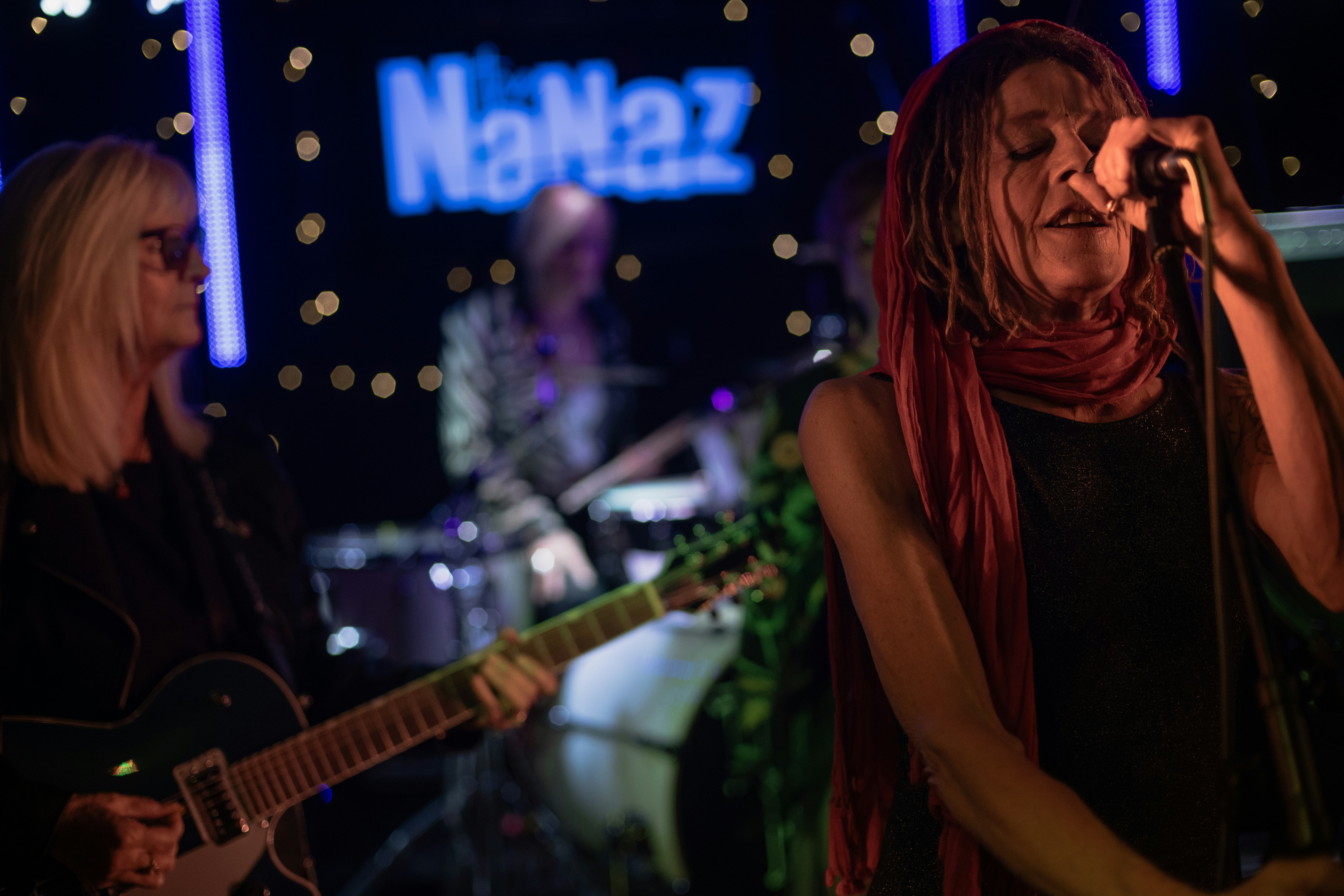 Singer performs with band on stage