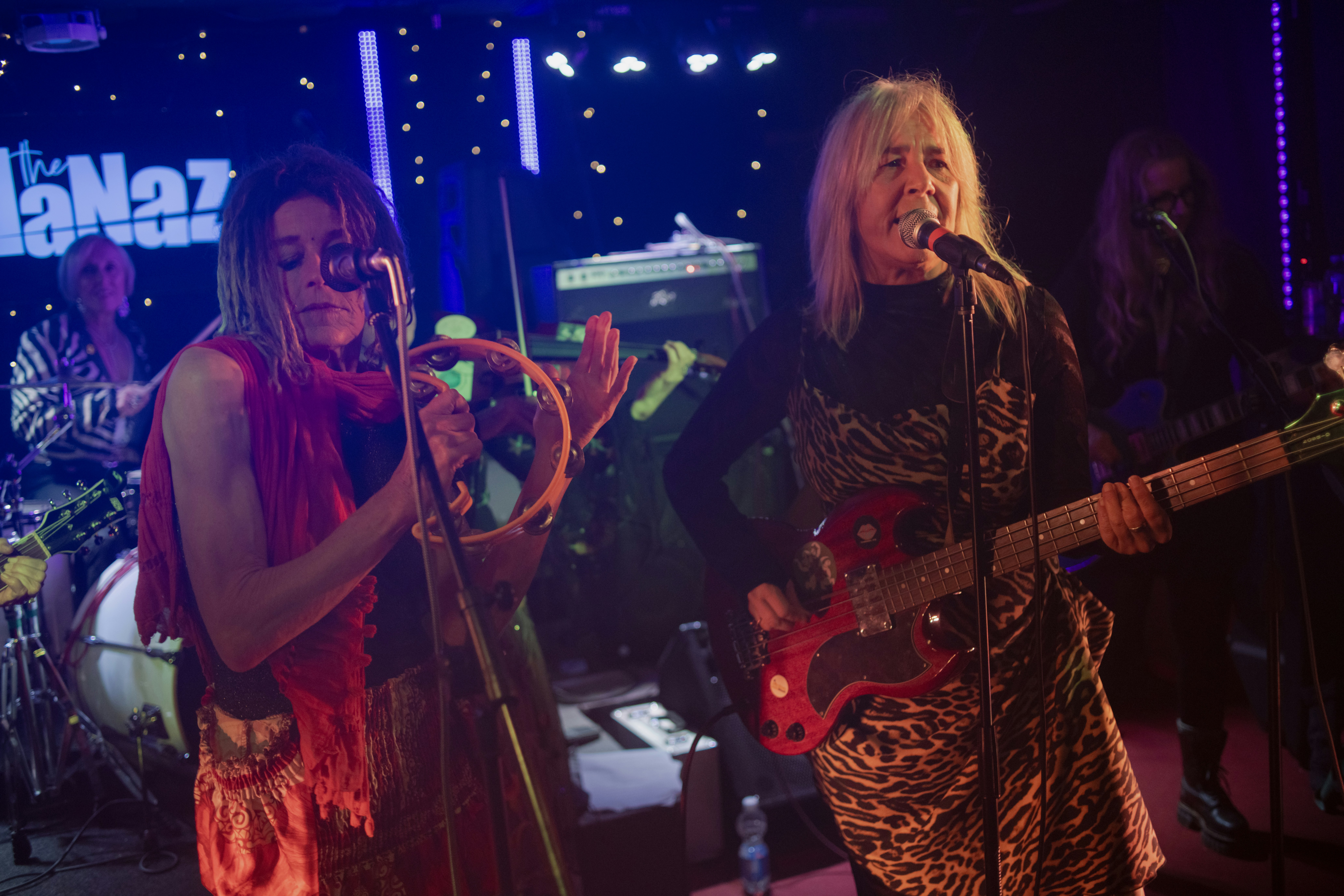 Women performing music on stage with instruments