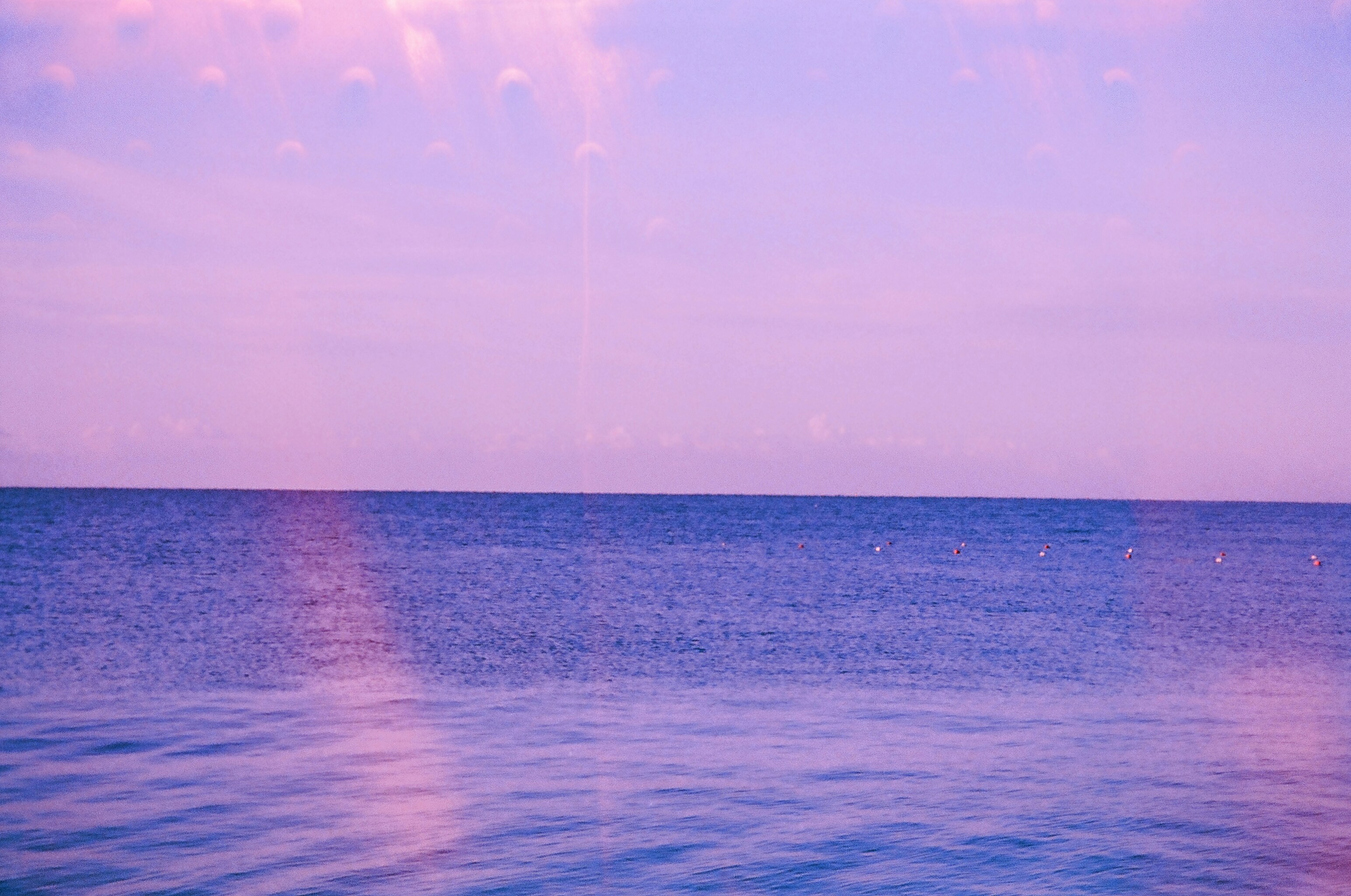 Calm ocean under a pastel pink and purple sky - 相关推荐