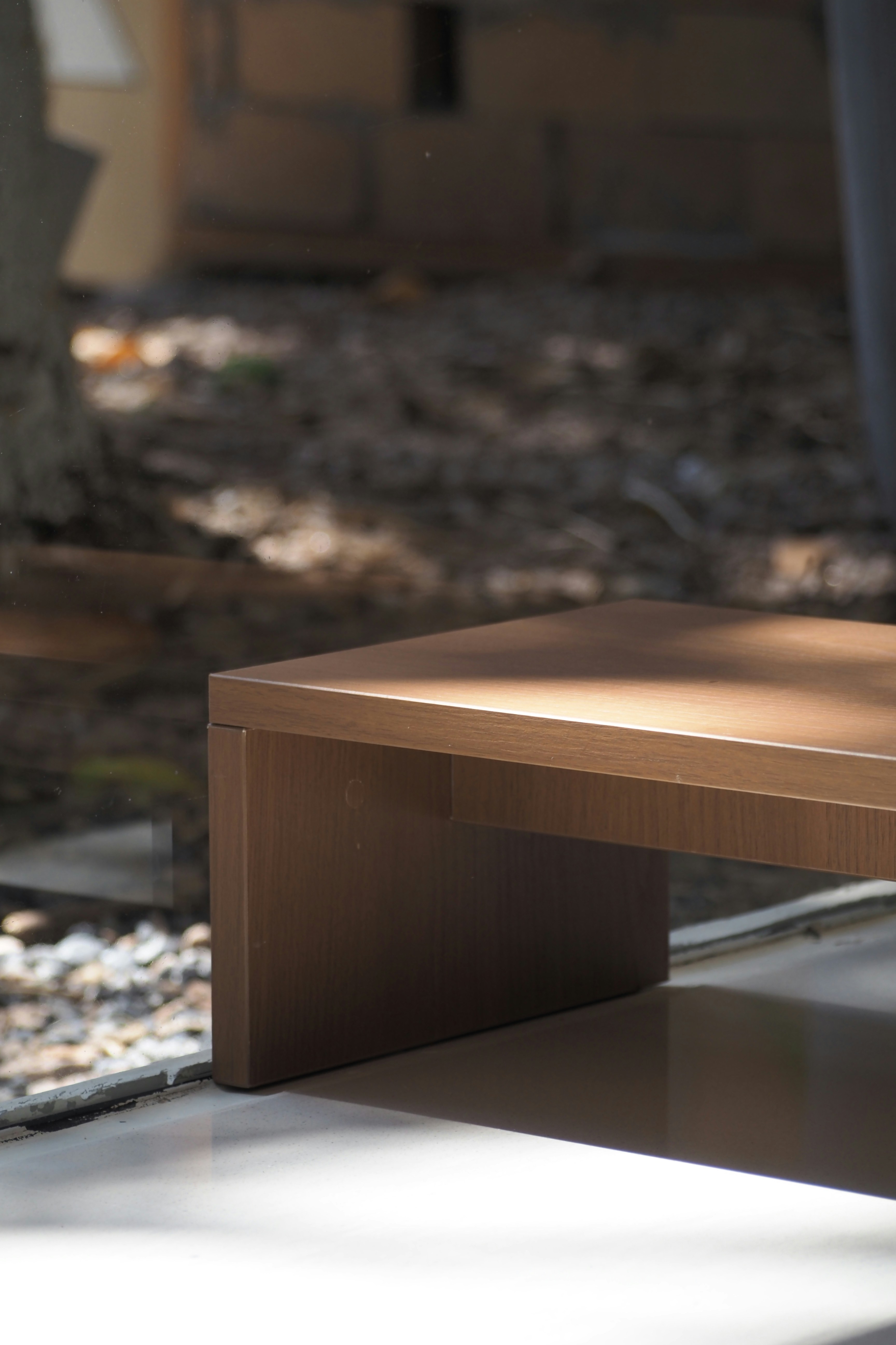 A wooden table in a sunlit outdoor setting.