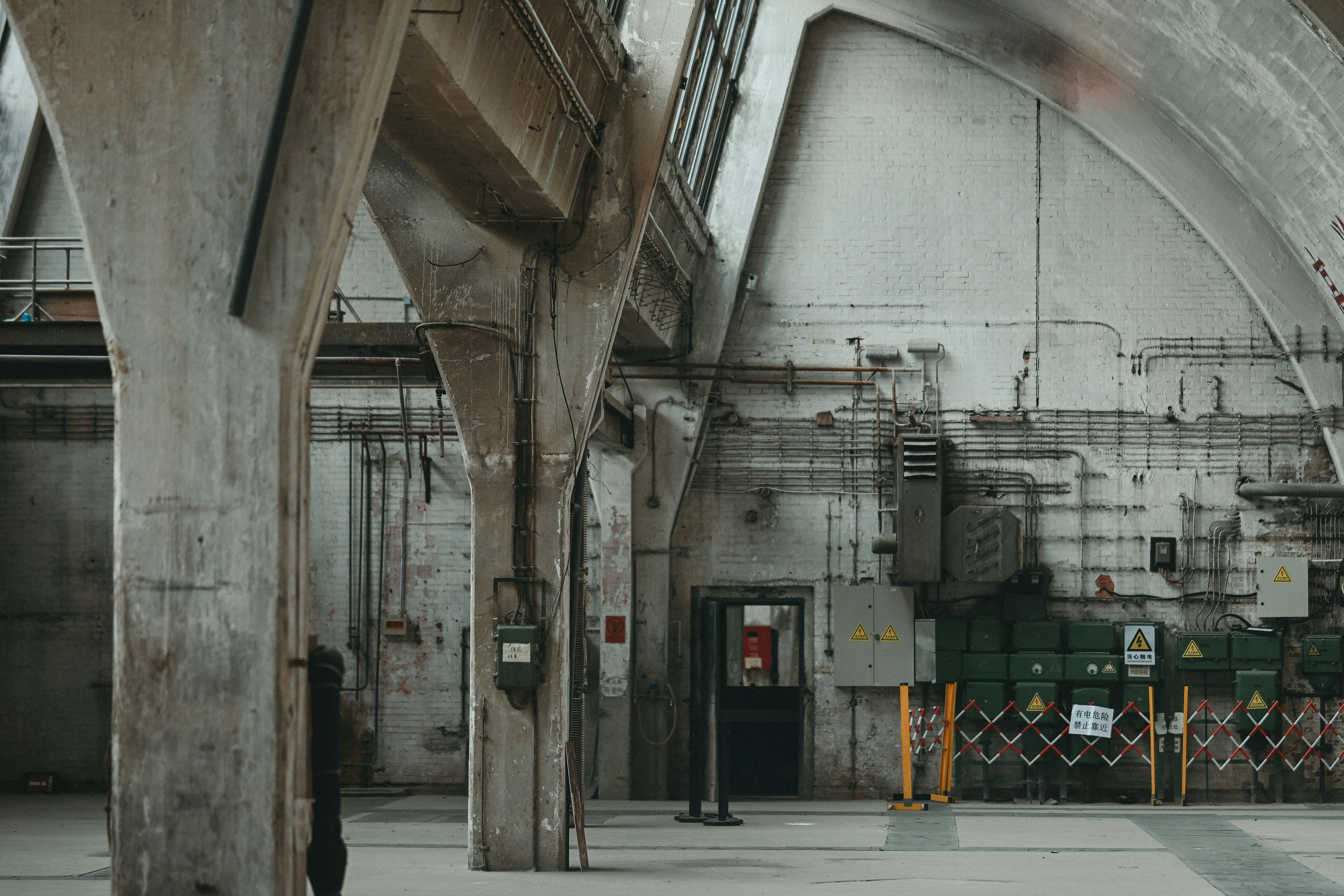 Vast industrial interior with concrete columns and machinery