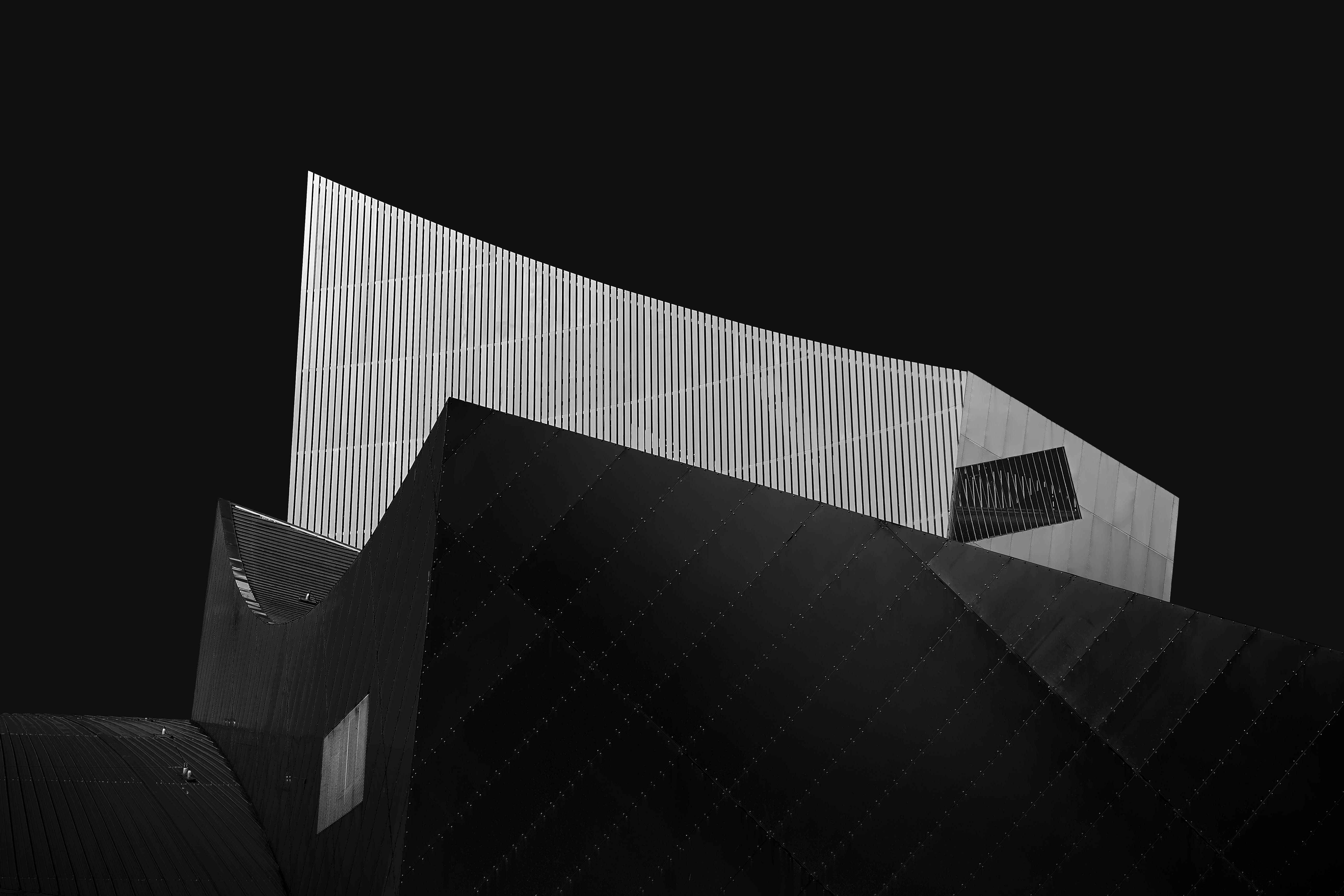 Modern architectural building with sharp angles against dark sky