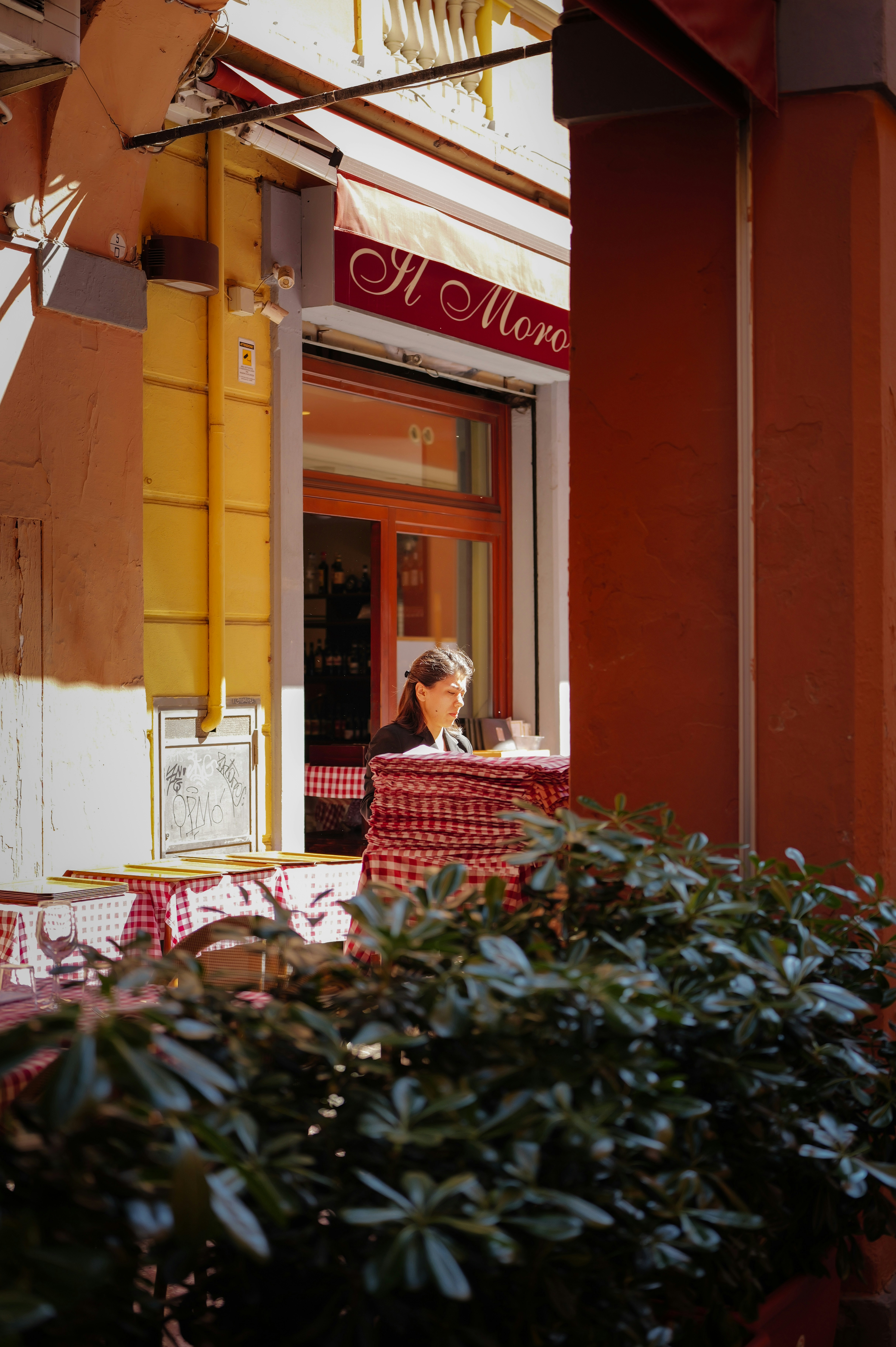 Woman reading at outdoor cafe table