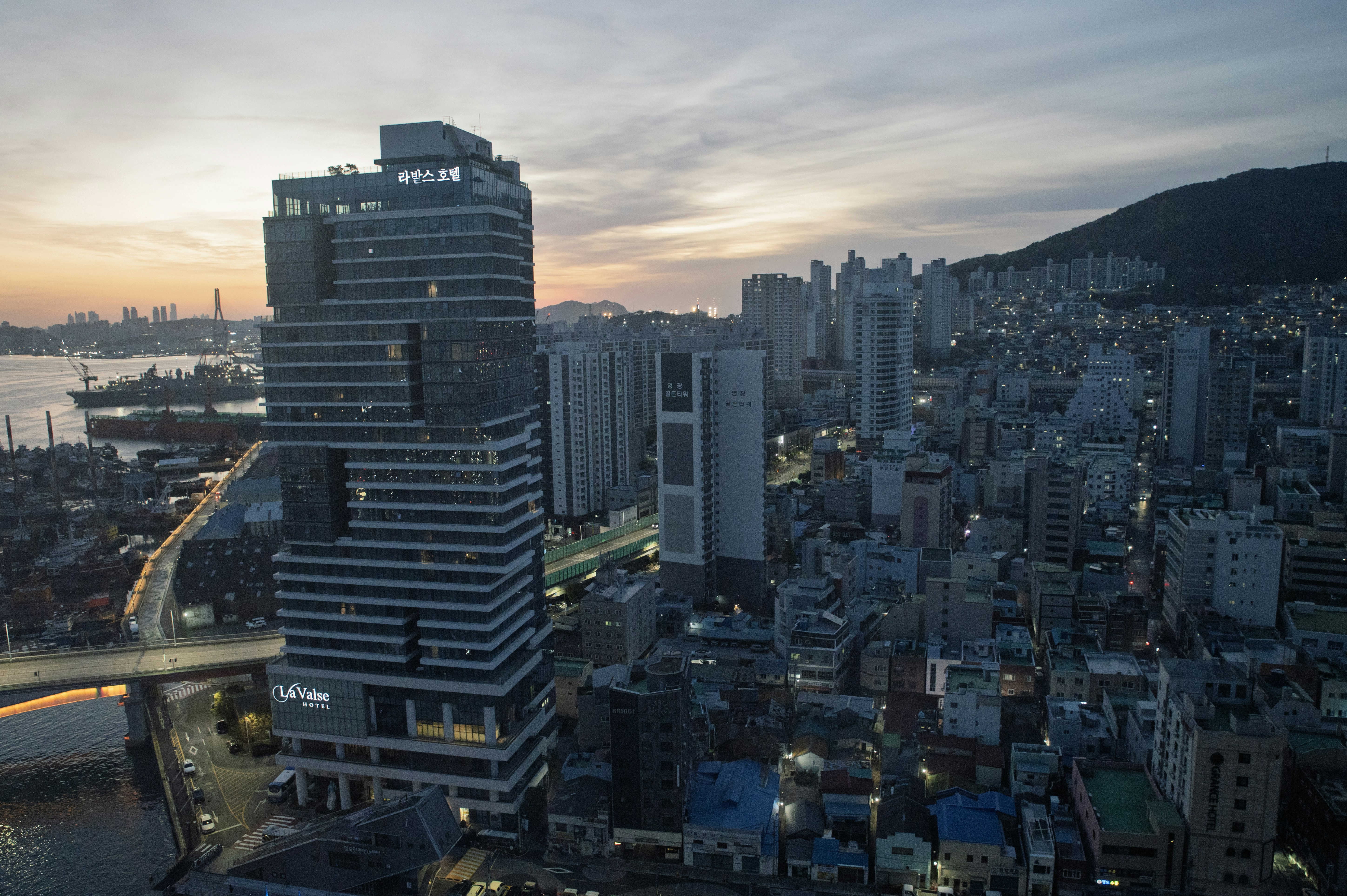 South Korea startup venture capital funding - Modern skyscraper in a dense urban cityscape at dusk.