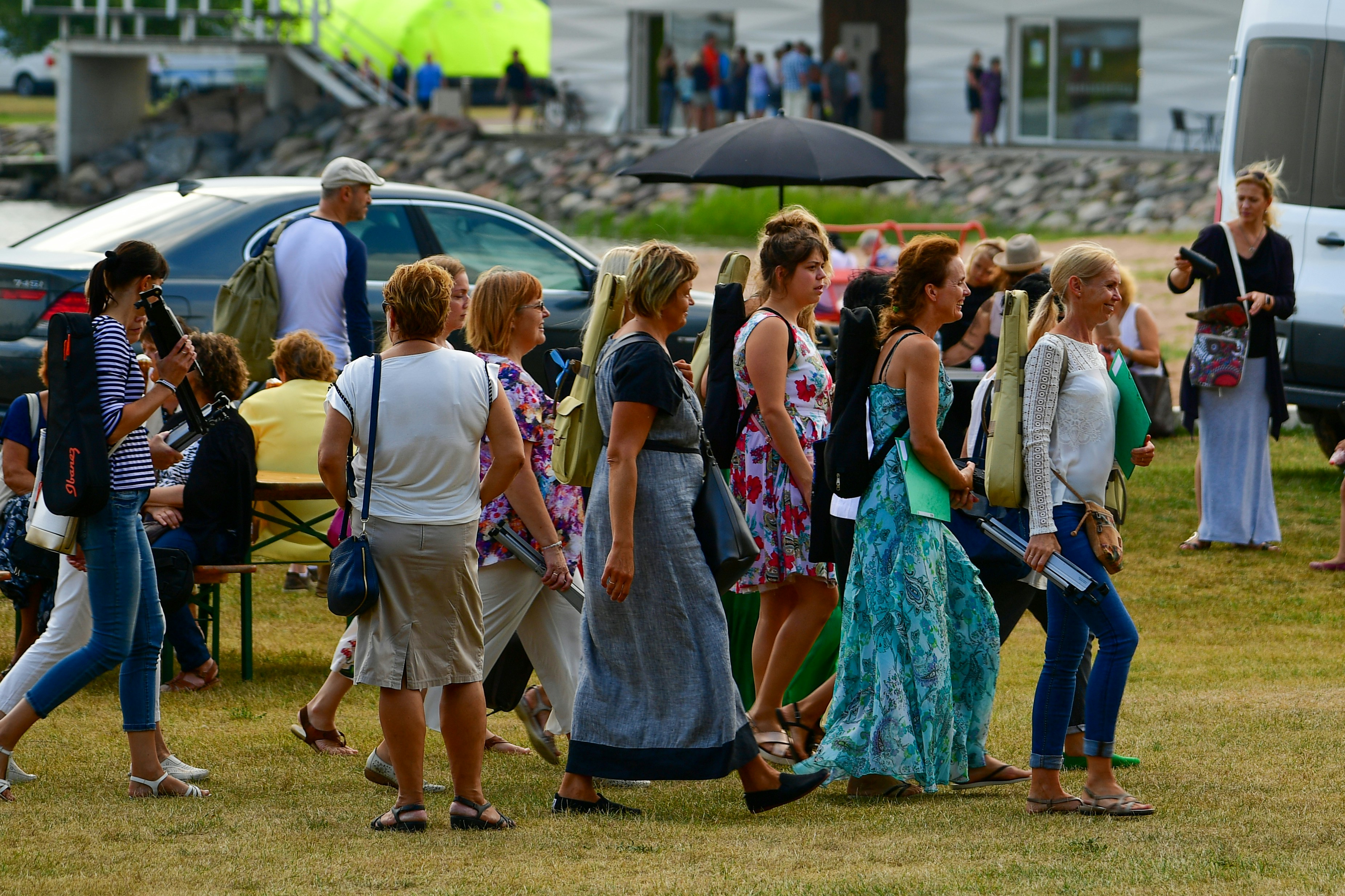 A group of women walking outdoors at an event.