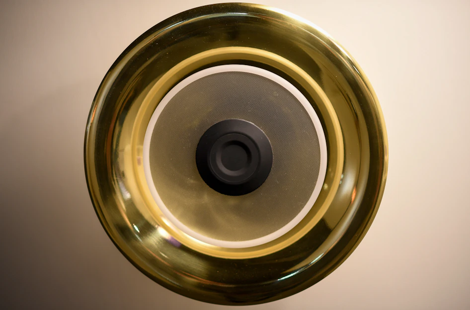 Close-up of a brass bell with a black center.