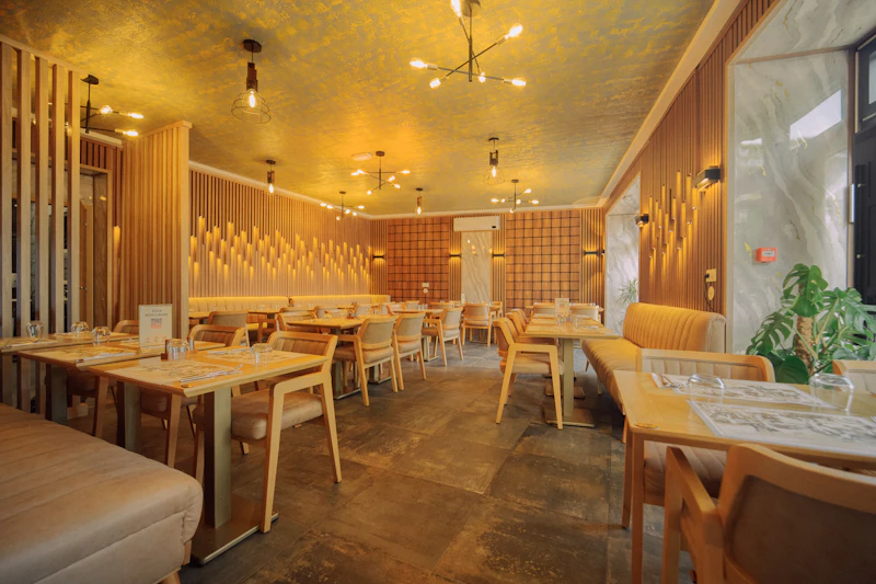 Modern Korean restaurant interior with warm ambient lighting, wood-panelled walls, and contemporary seating