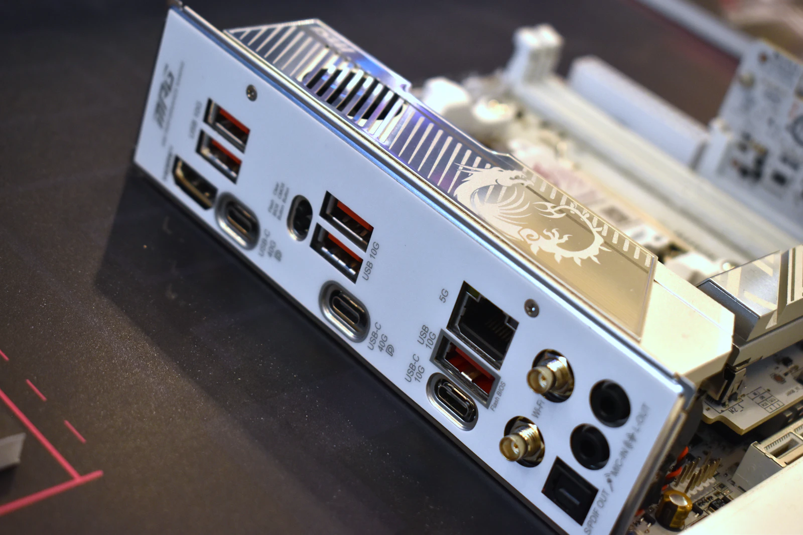 White MSI MAG motherboard rear I/O panel showing an HDMI port, USB-C 40G and 10G ports, a 5G Ethernet jack, red USB 10G ports, Wi-Fi antenna connectors, and audio jacks