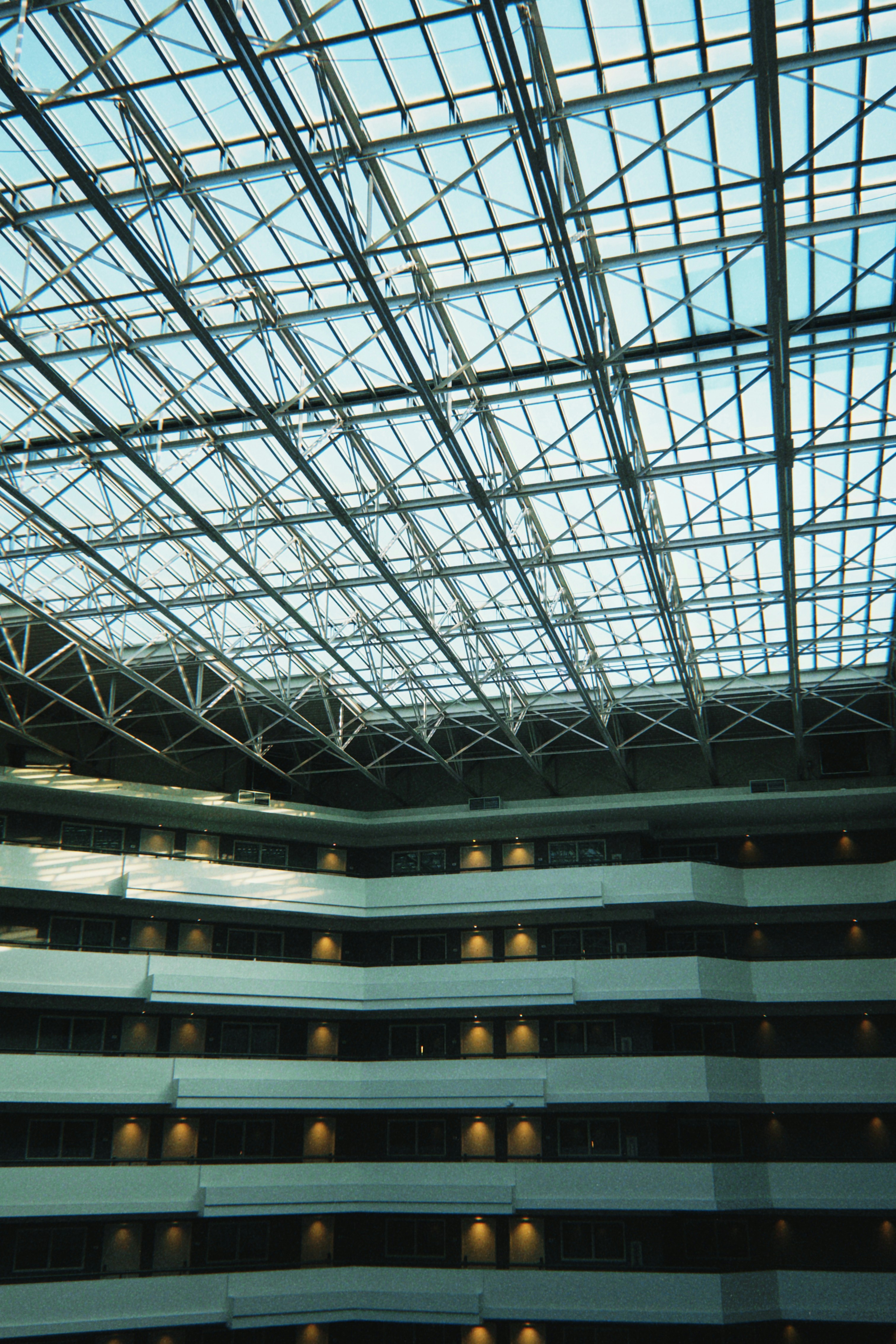 Modern building interior with glass ceiling and balconies