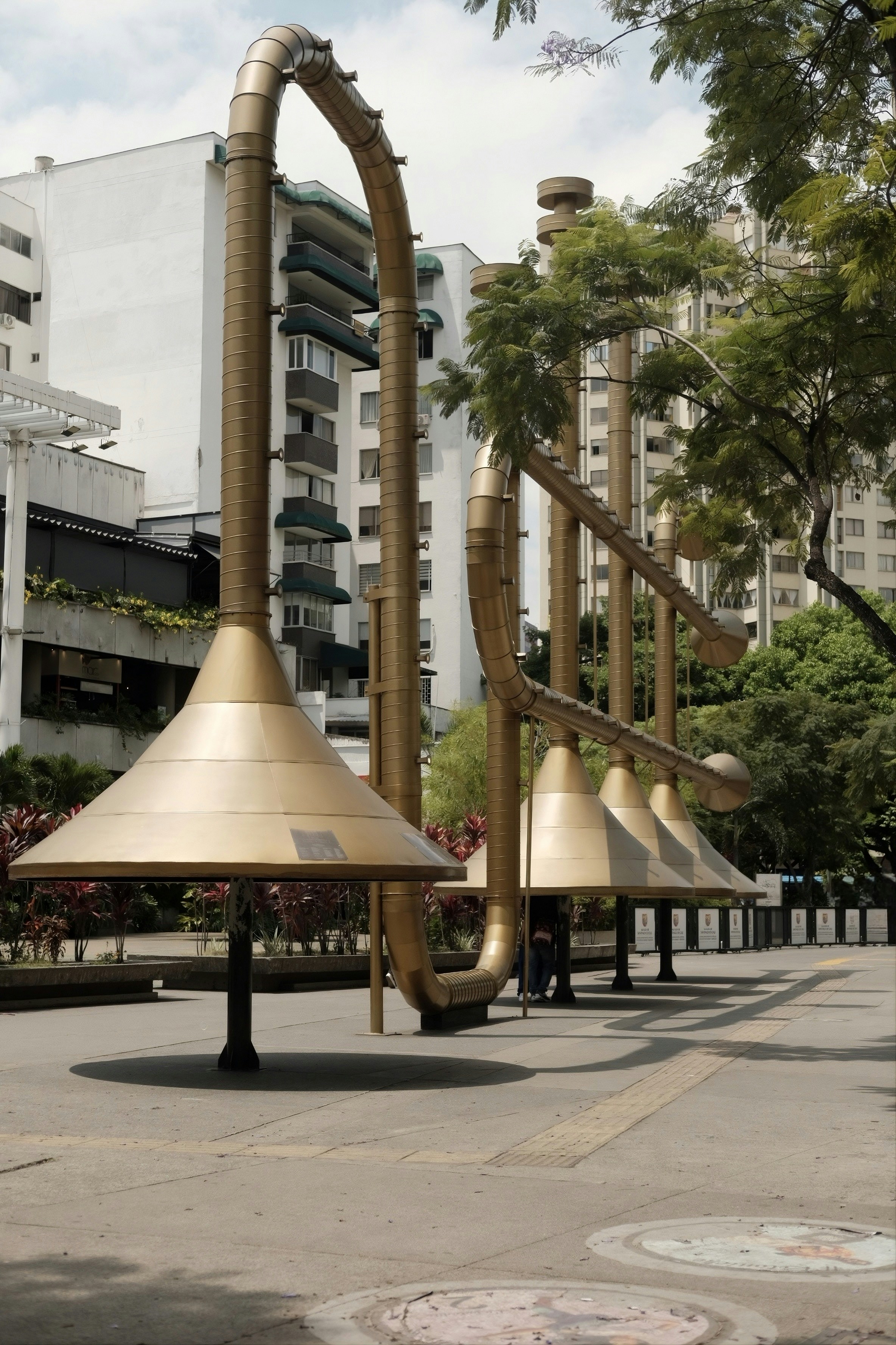 Large golden musical instrument sculpture in a park - Free Photo on ...