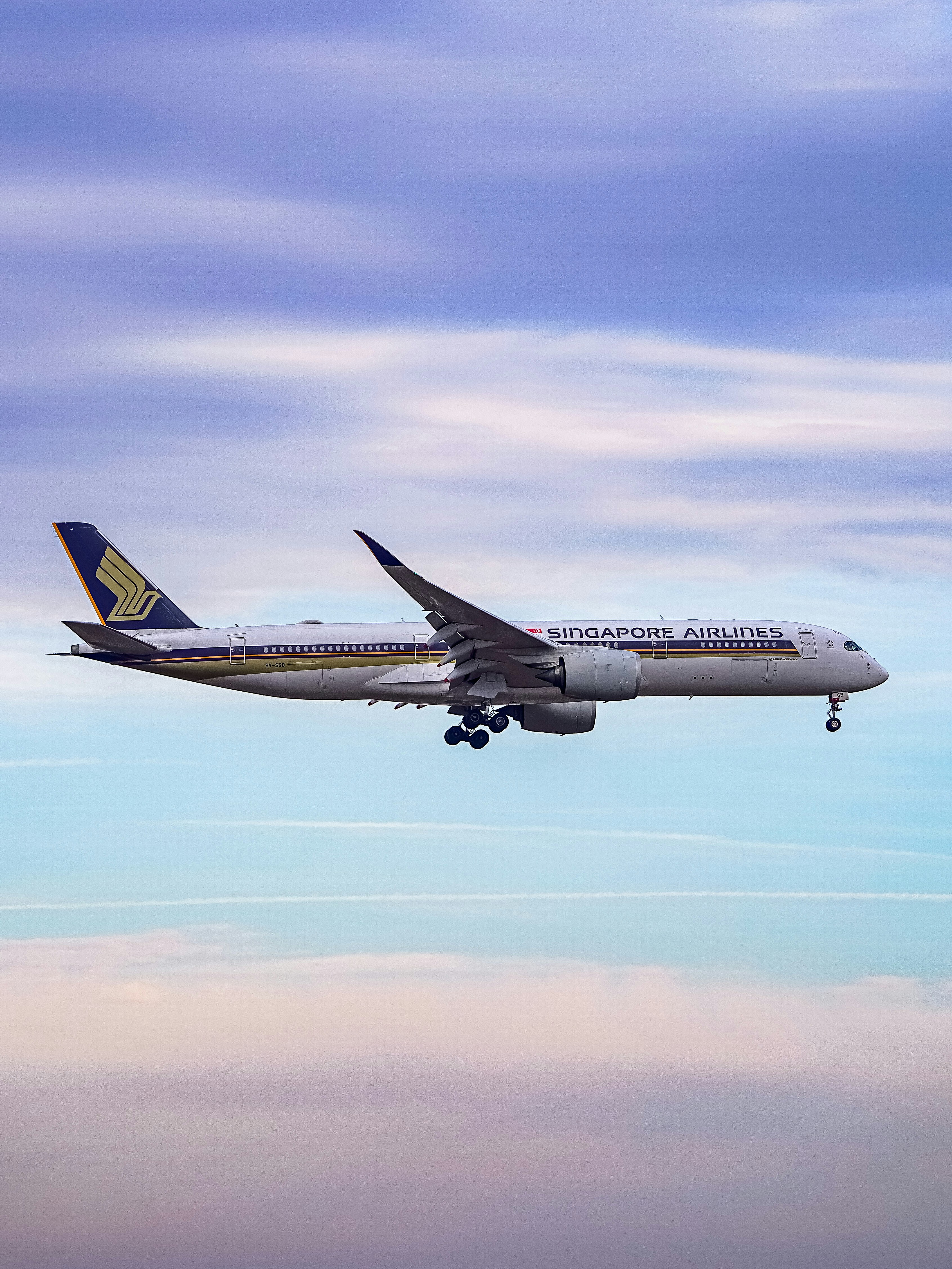Singapore airlines airplane flying in a cloudy sky