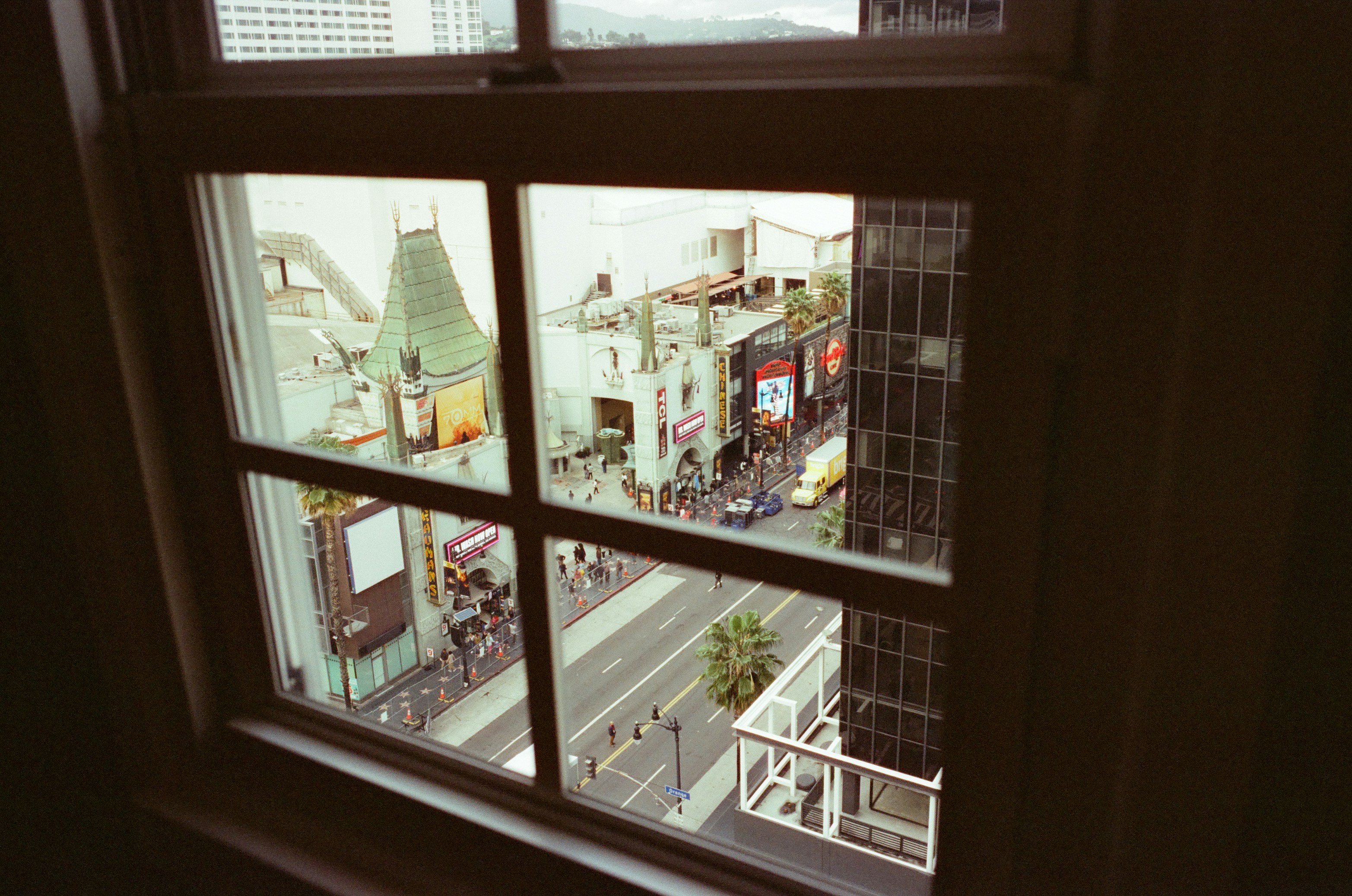 View of a city street with buildings through a window.