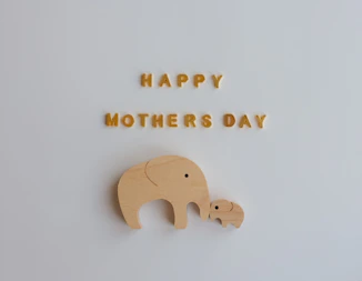 Happy mothers day with wooden elephants