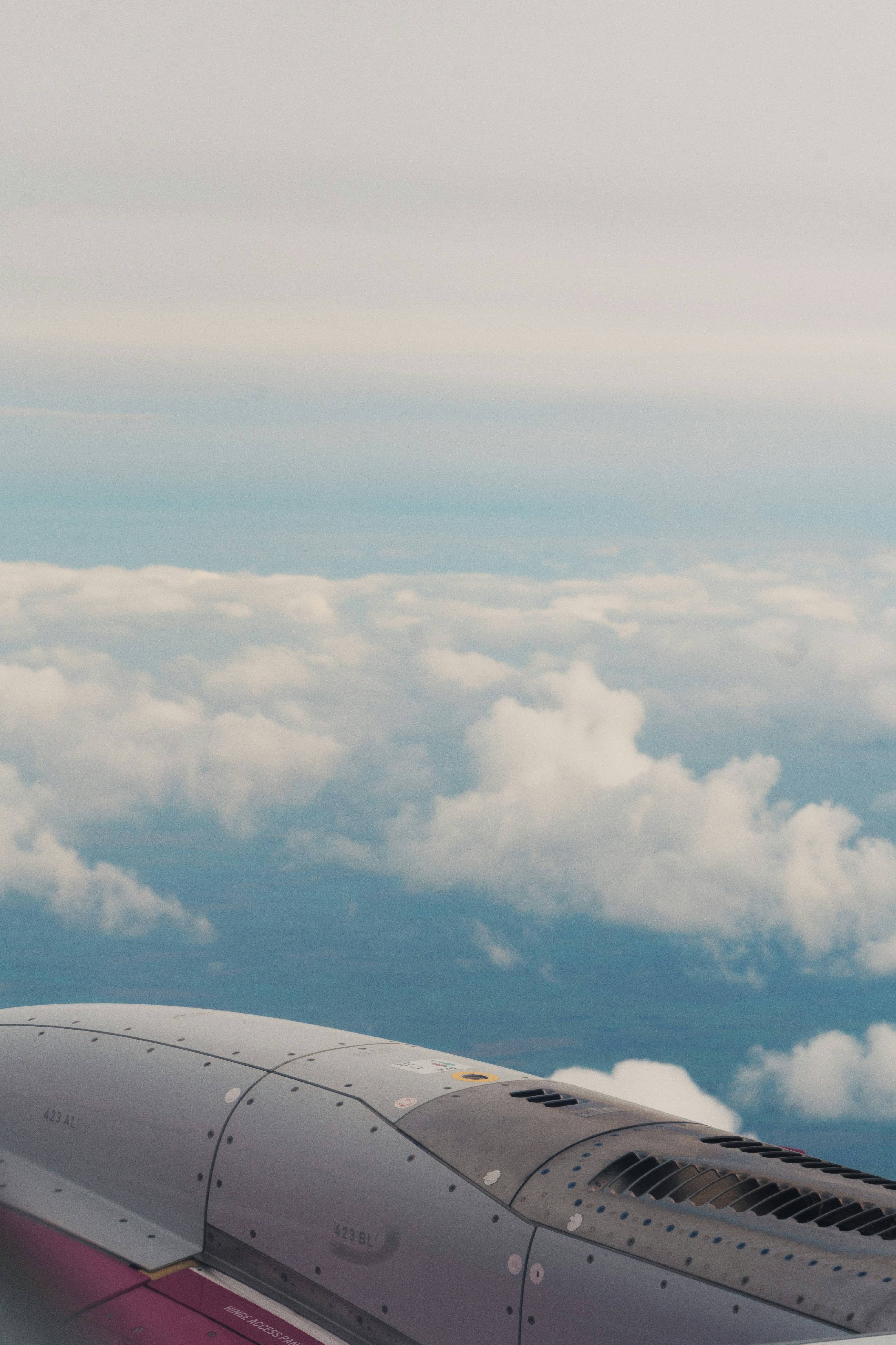 View from airplane window over clouds
