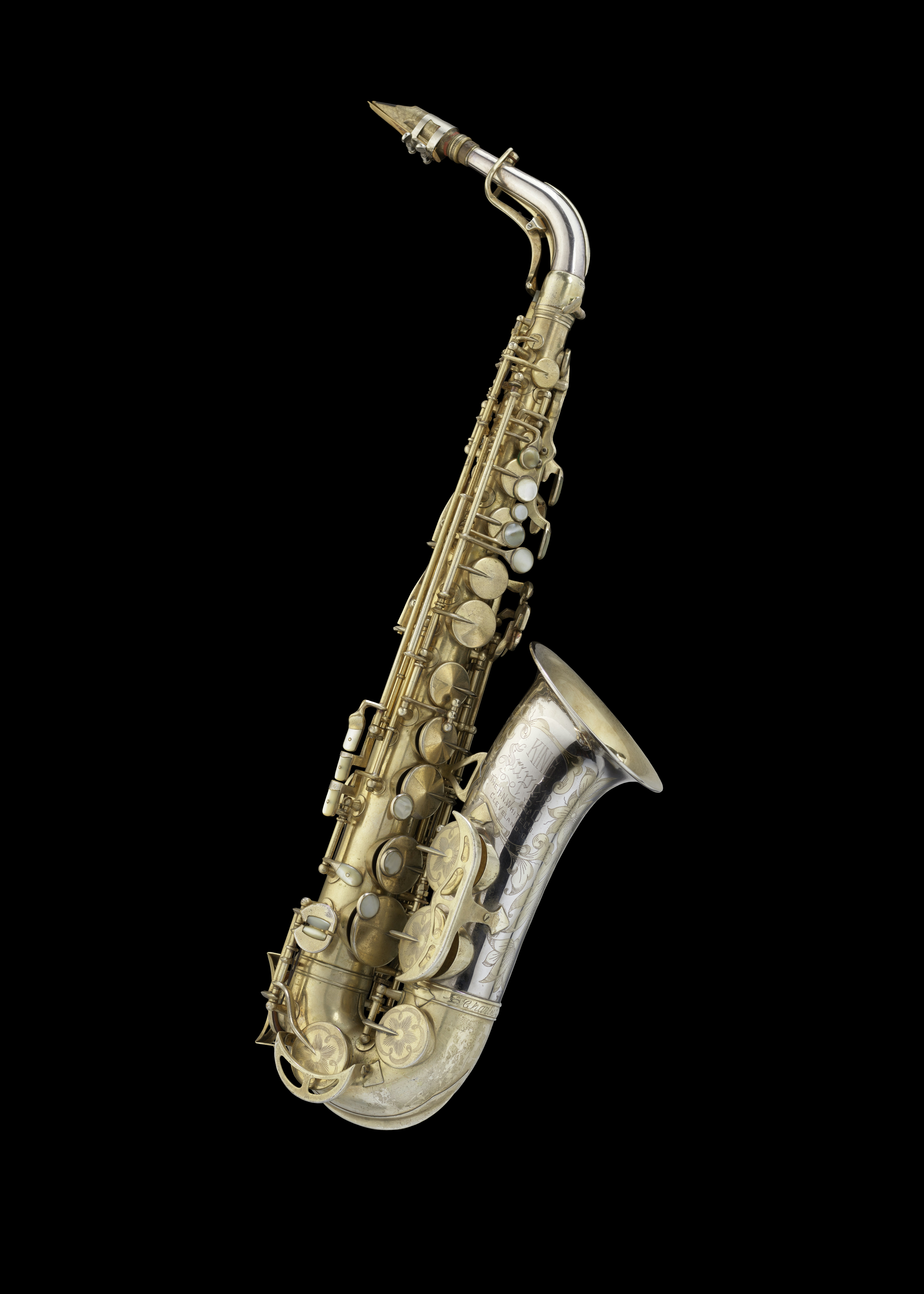 A vintage saxophone on a black background