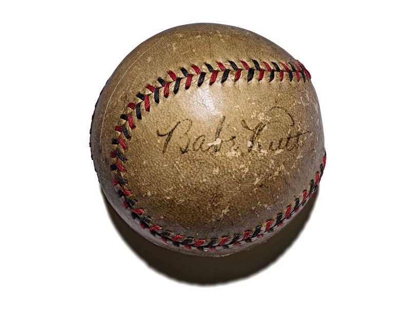 A vintage baseball with a faded signature.