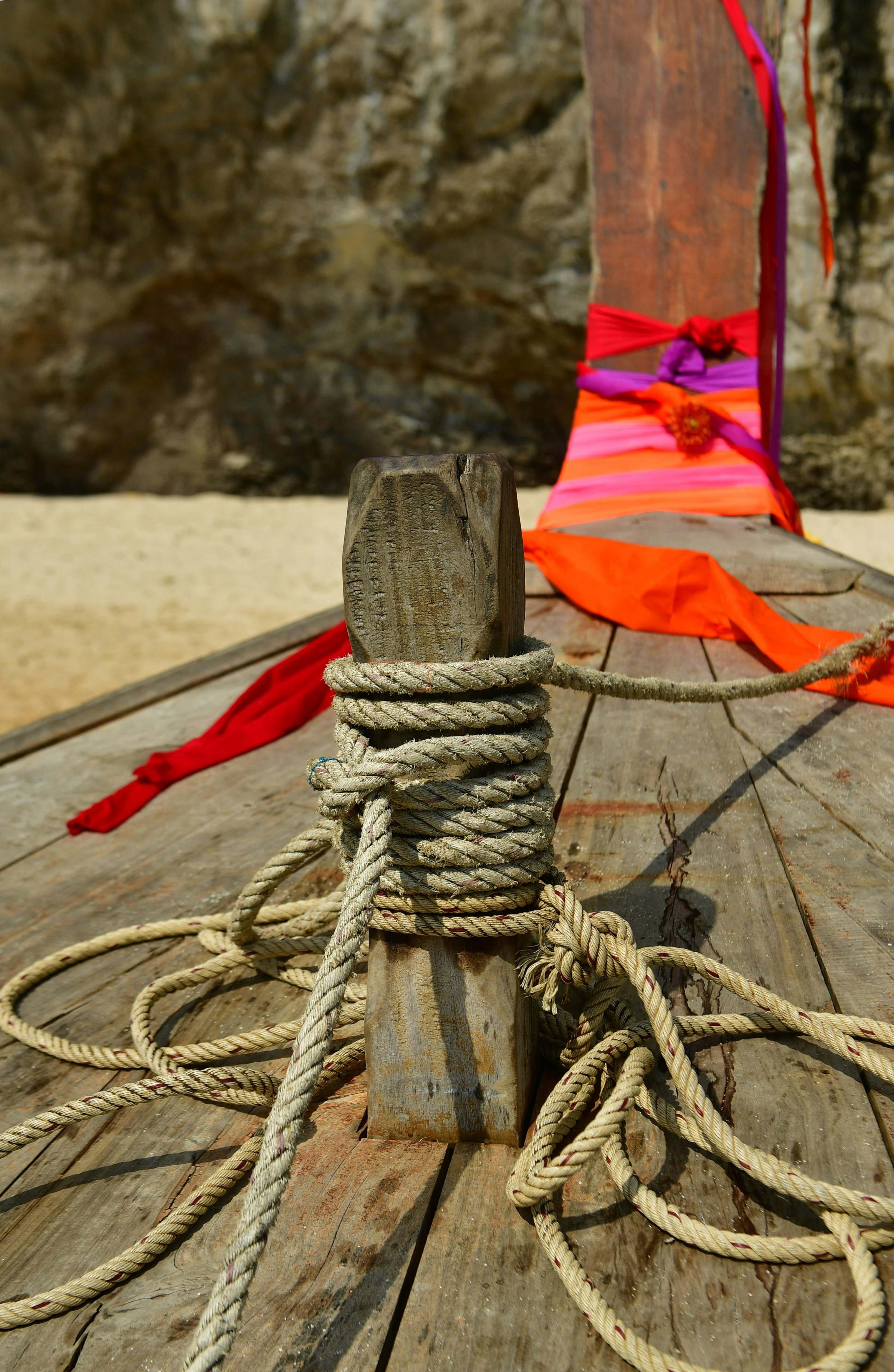 Wooden boat bow with ropes and colorful ribbons