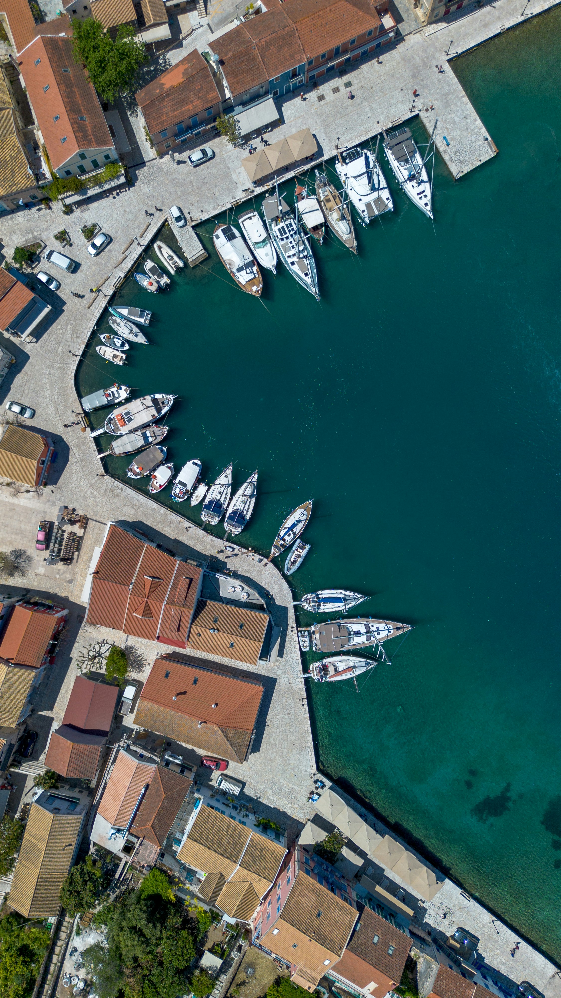 Aerial view of boats docked in a mediterranean harbor.
