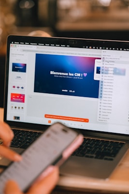 Person using laptop and phone for digital marketing