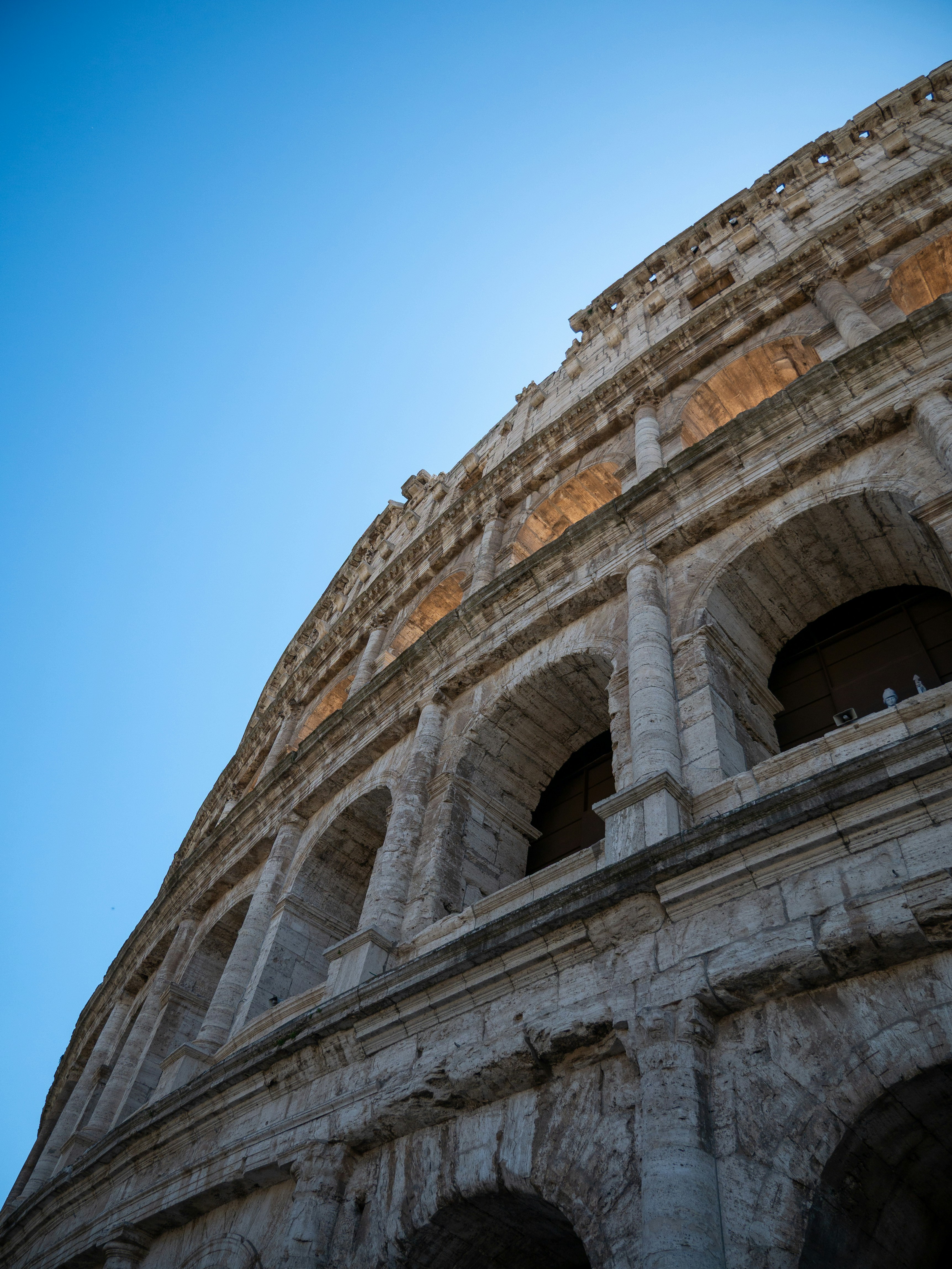 The colosseum in rome under a clear blue sky