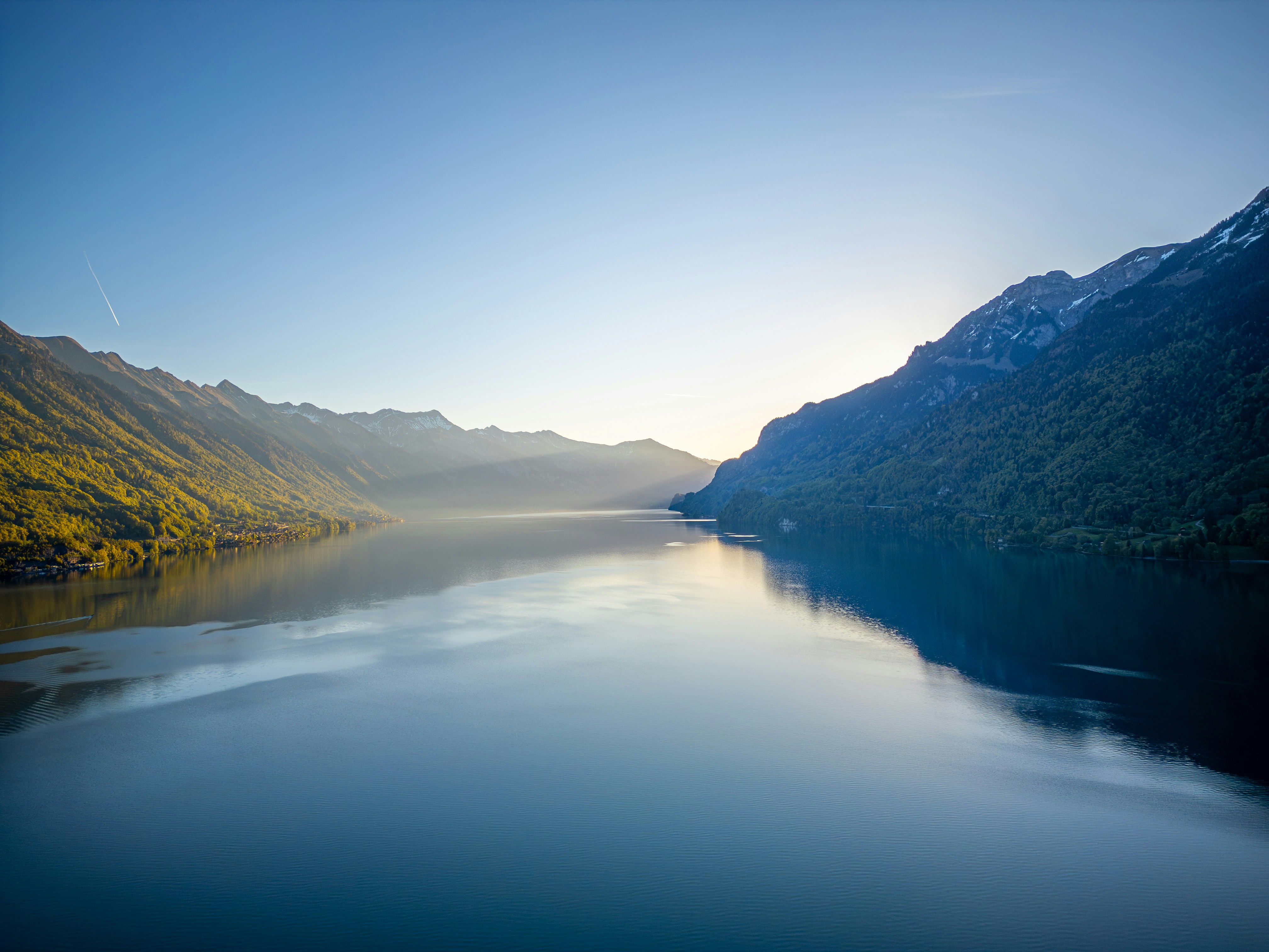 Calm lake between mountains at sunrise