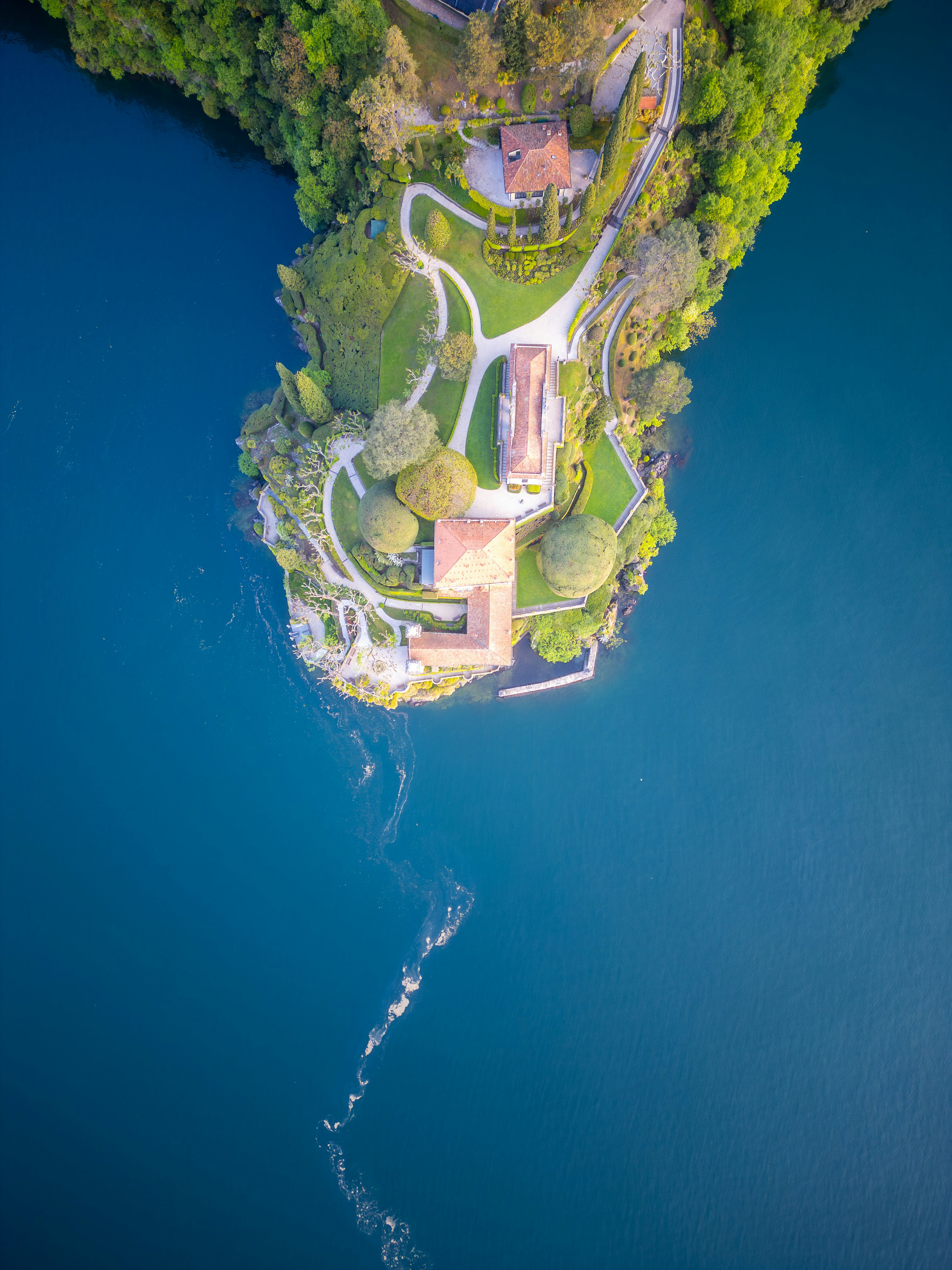 Aerial view of a small island with buildings and trees.