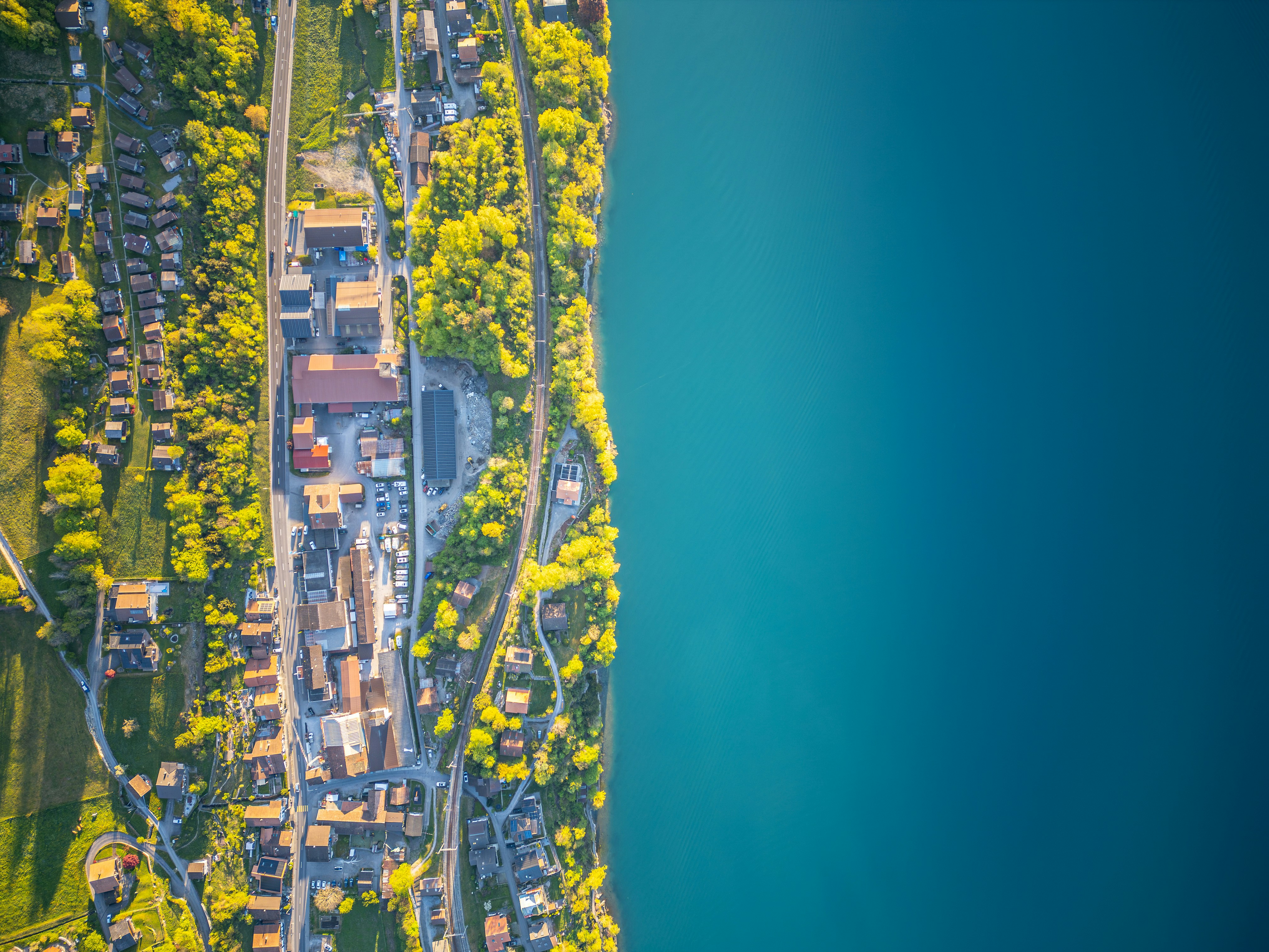 Aerial view of a town along a bright blue lake