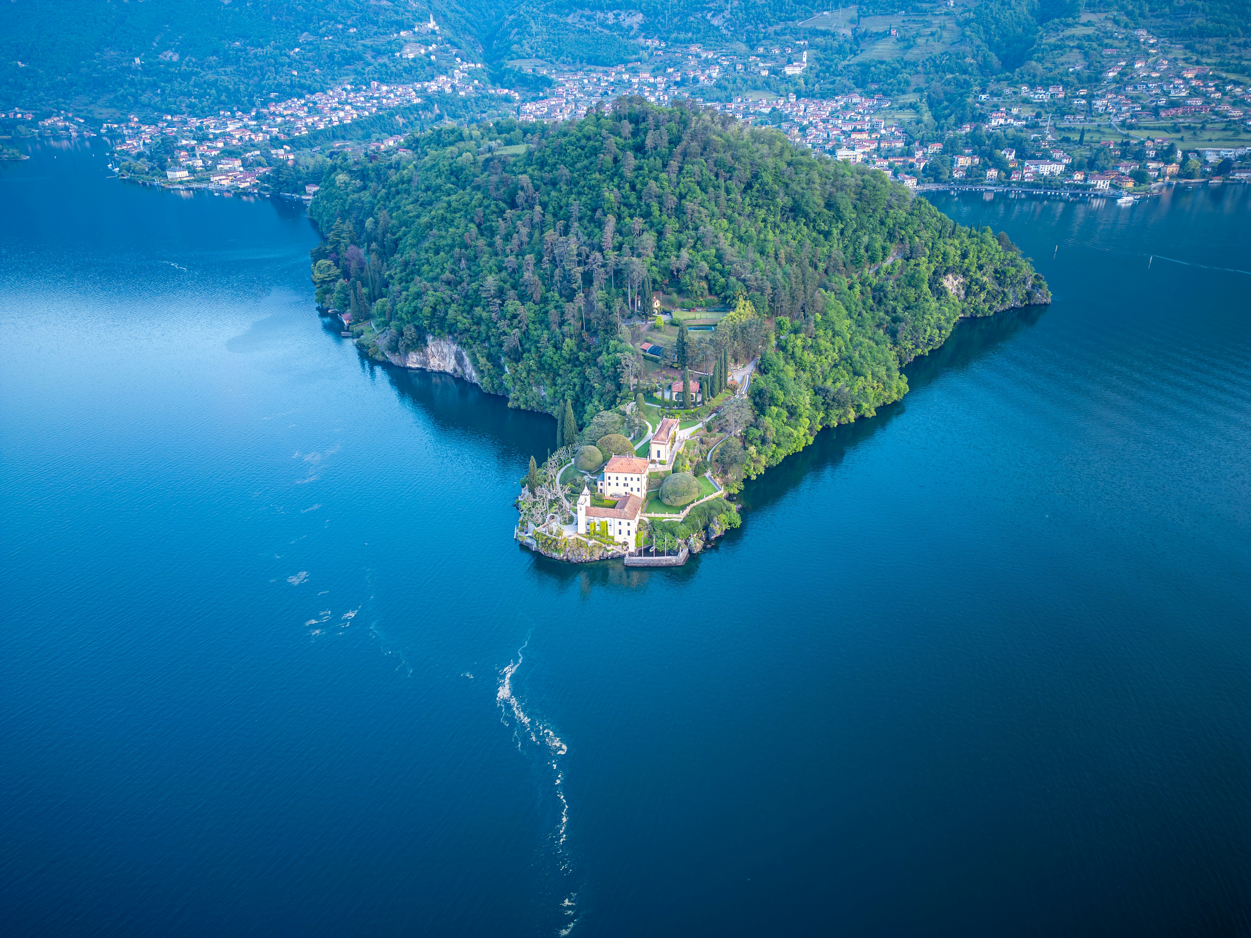 Island with buildings surrounded by deep blue water