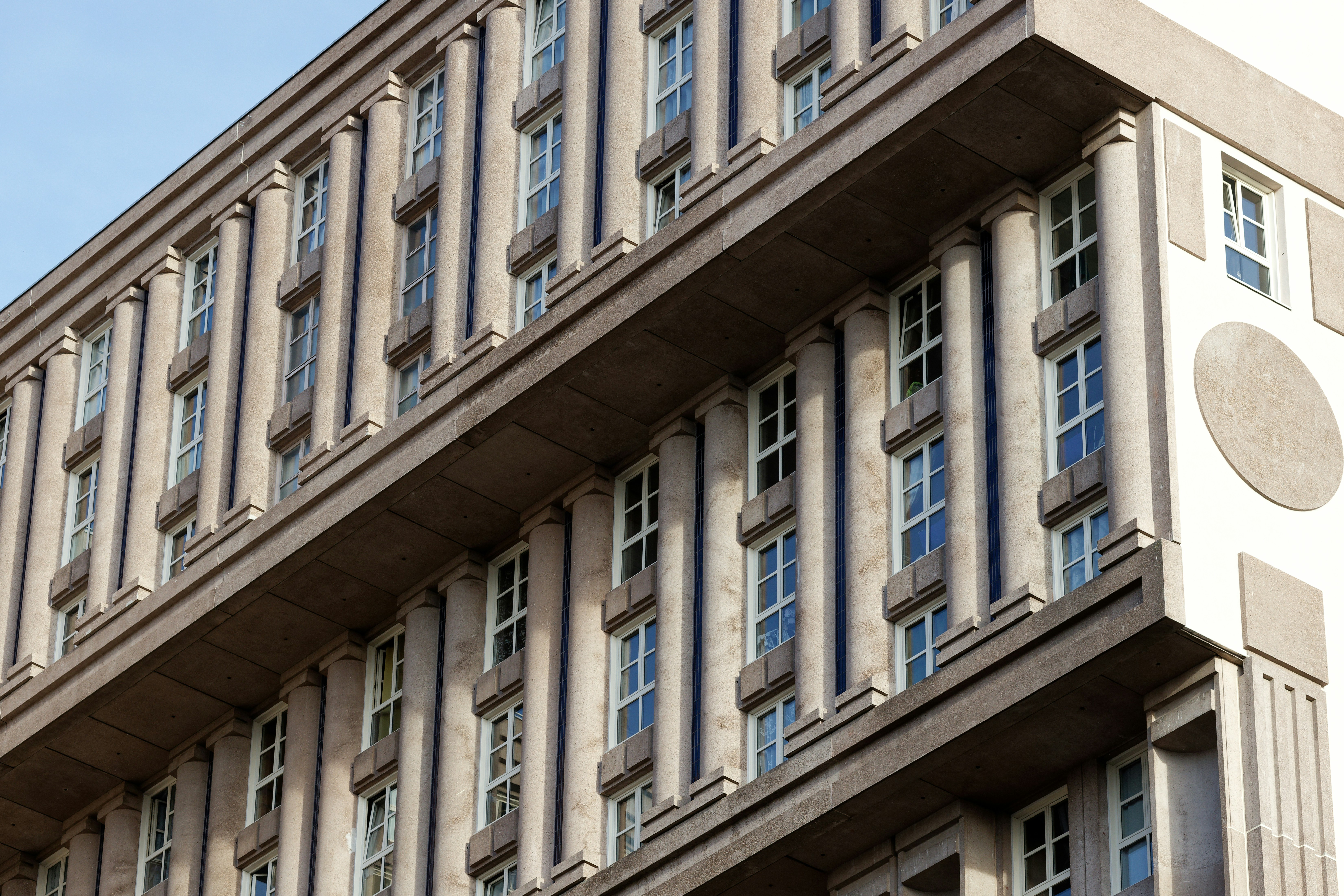 A modern building with many windows and columns