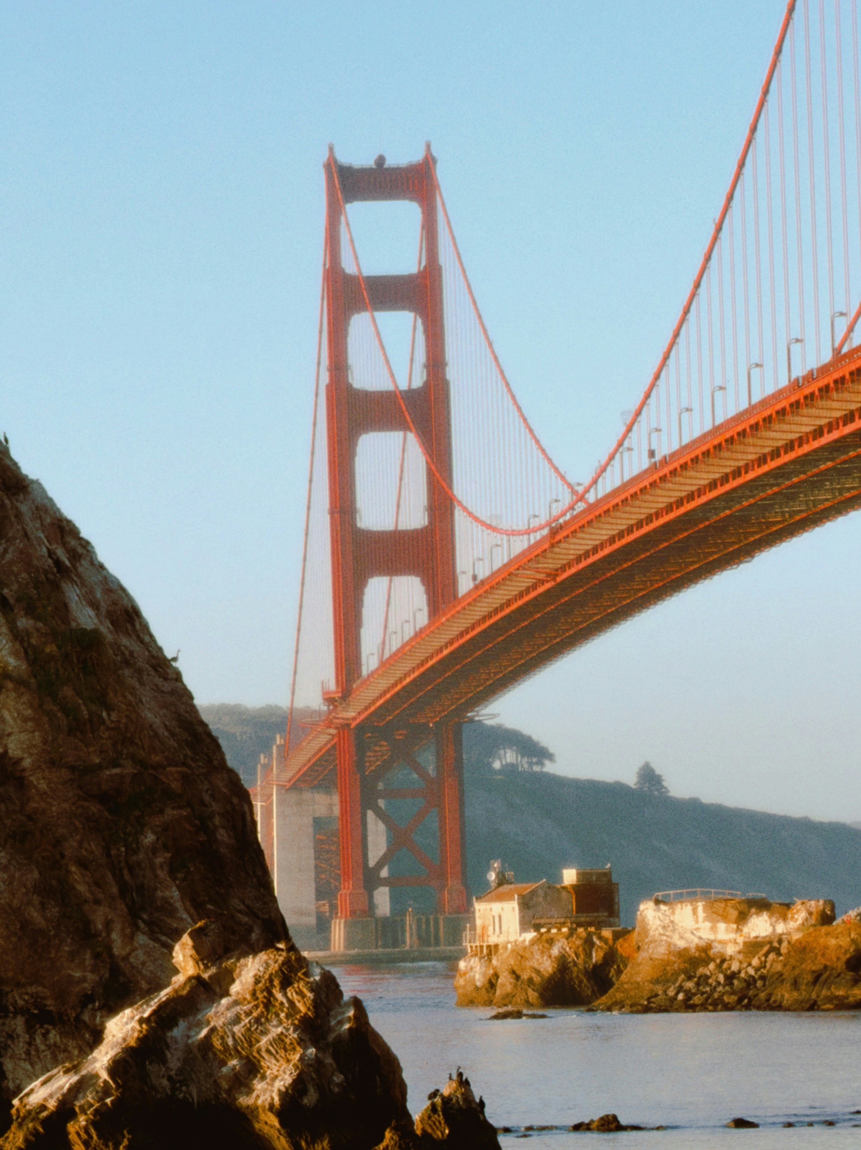 The golden gate bridge spans across the water.