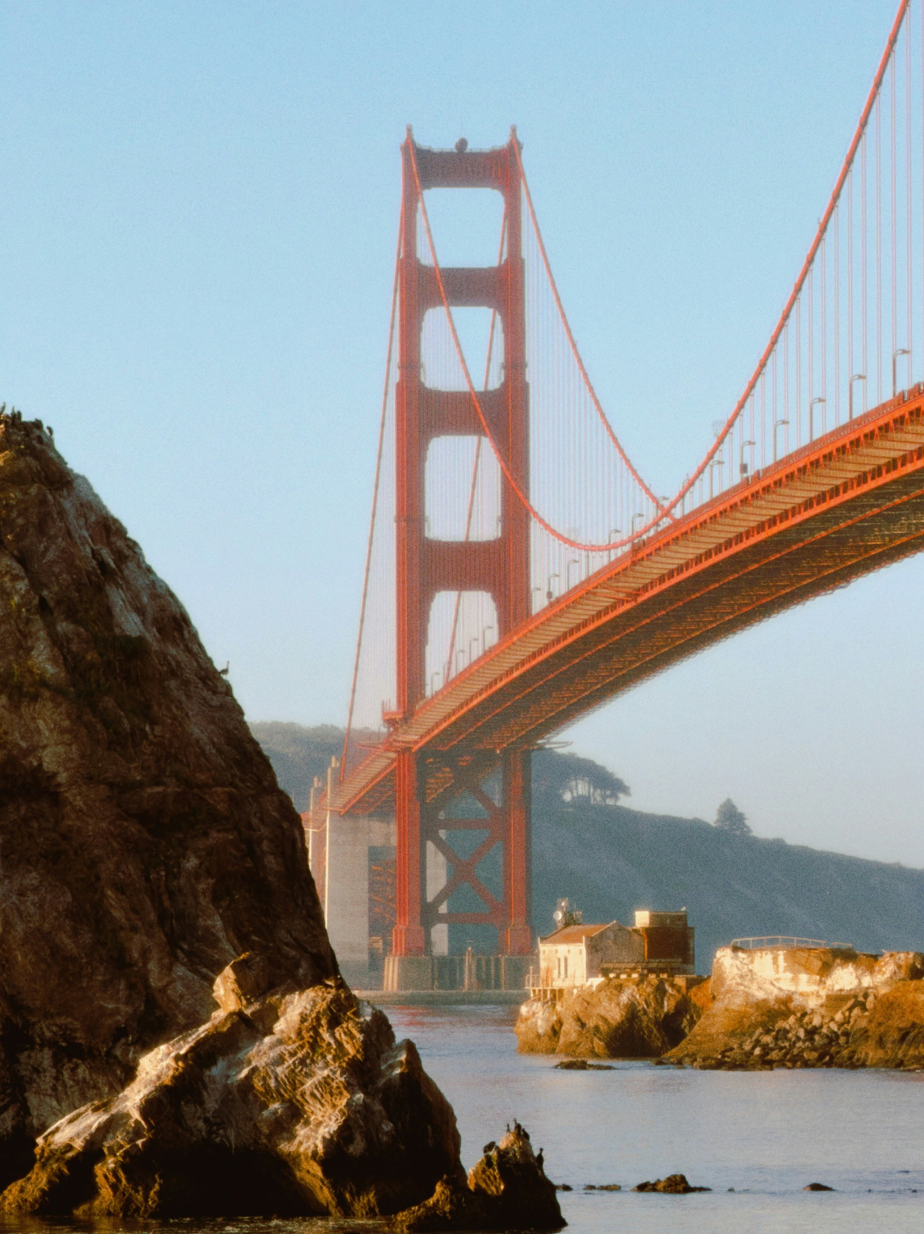The golden gate bridge spans across the water.