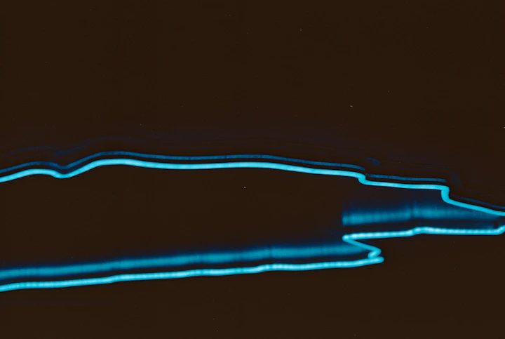 Glowing blue light streaks on a black background