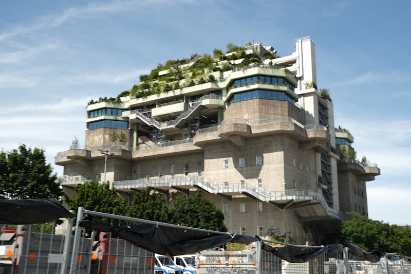 Concrete building with rooftop garden and blue accents