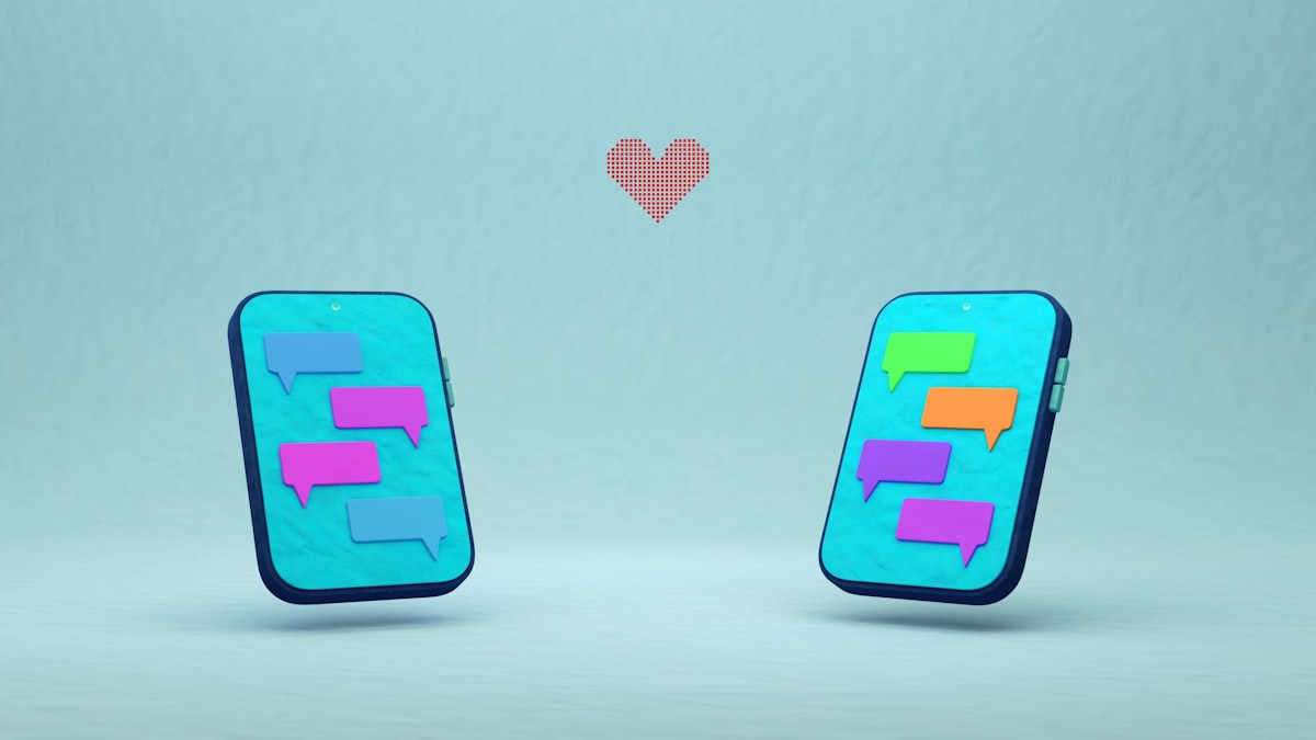 Two phones with chat bubbles and a red heart.