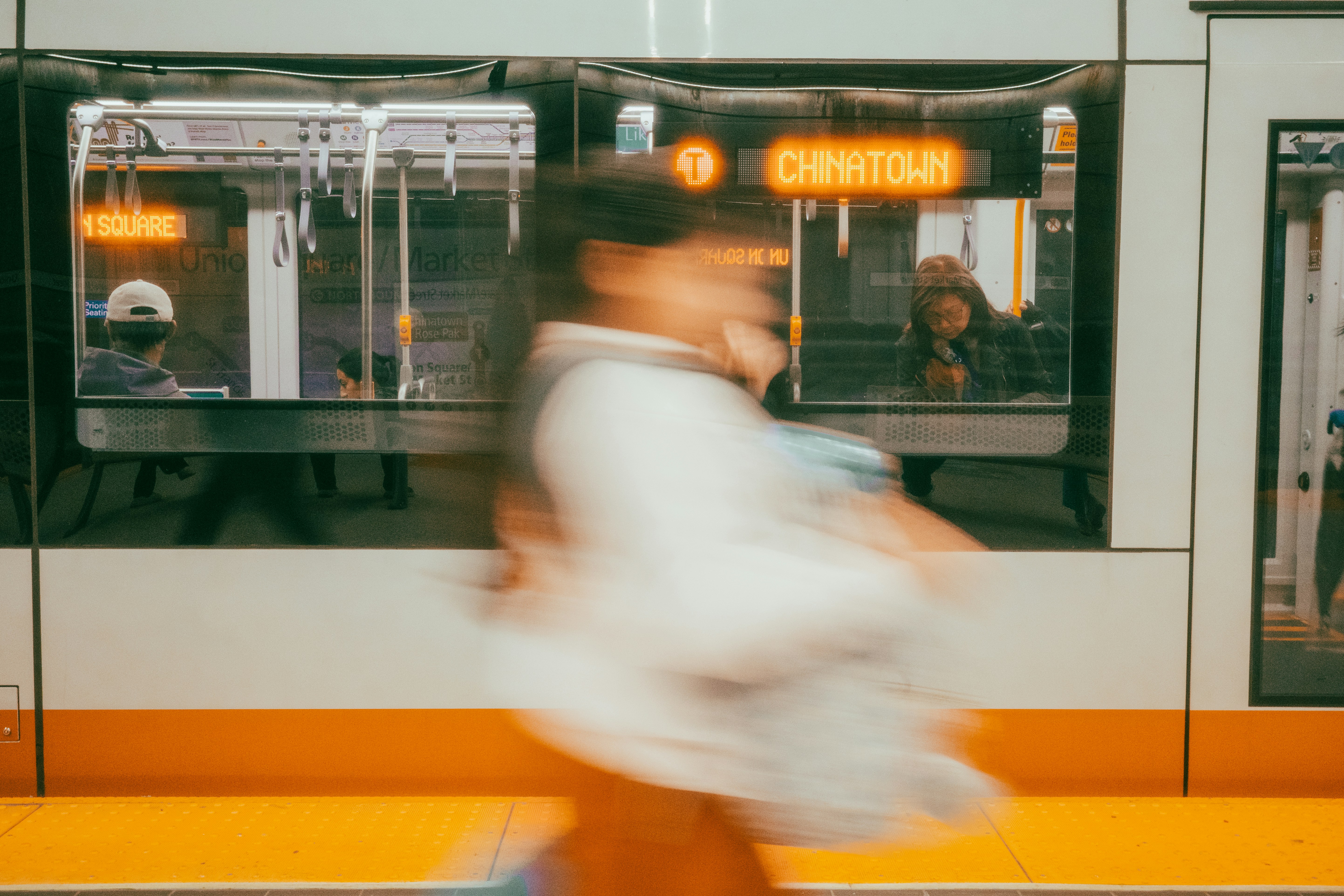 Person running past a train with destination sign