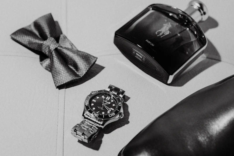 wealthy man's grooming essentials with watch and cologne