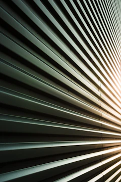 Abstract pattern of metal siding with sunlight
