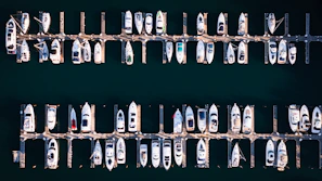 Many boats docked in a marina from above.