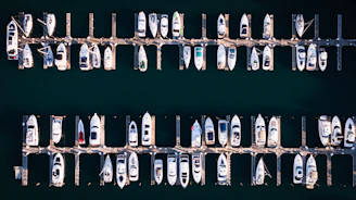 Many boats docked in a marina from above.