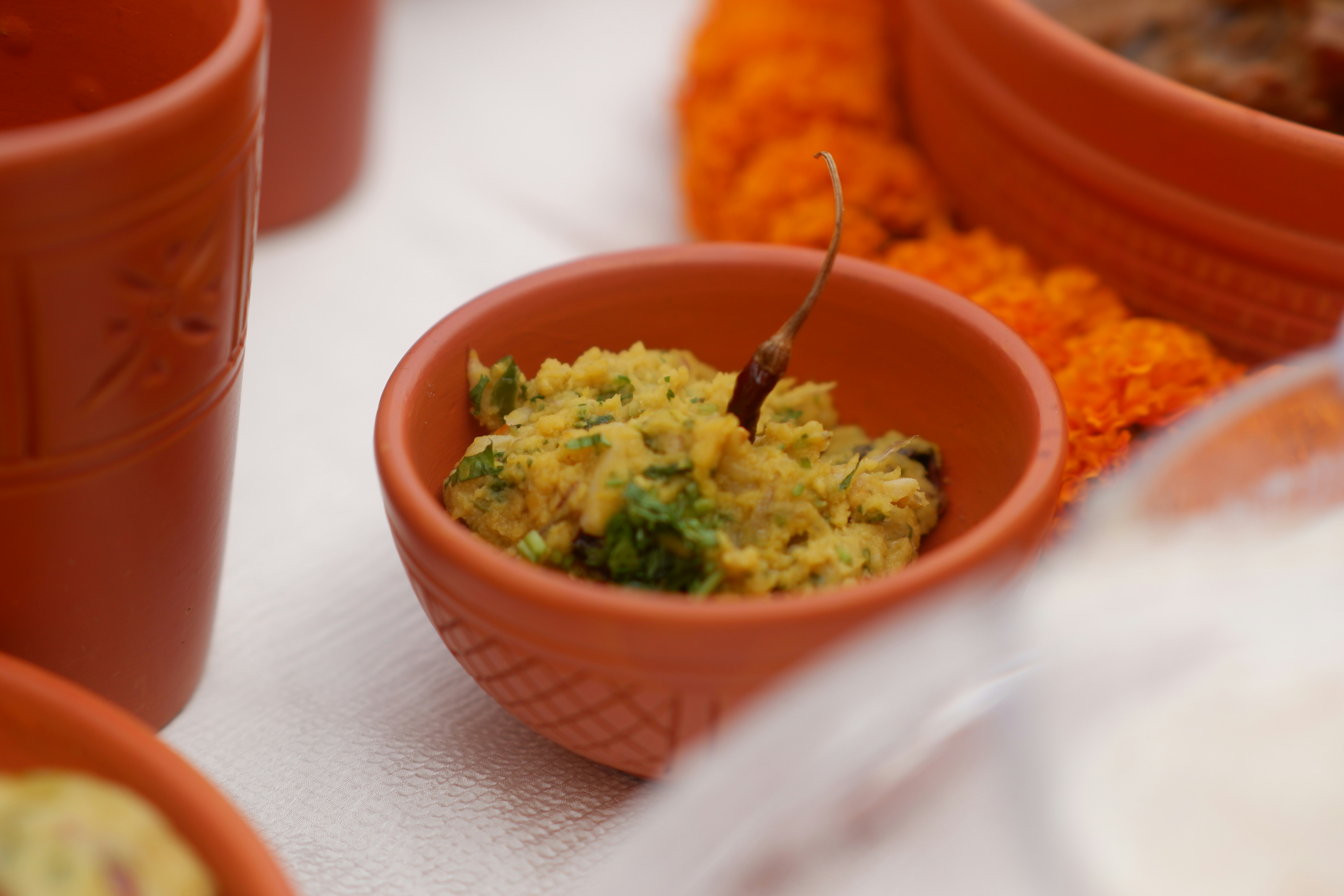A small bowl of food with a chili pepper.