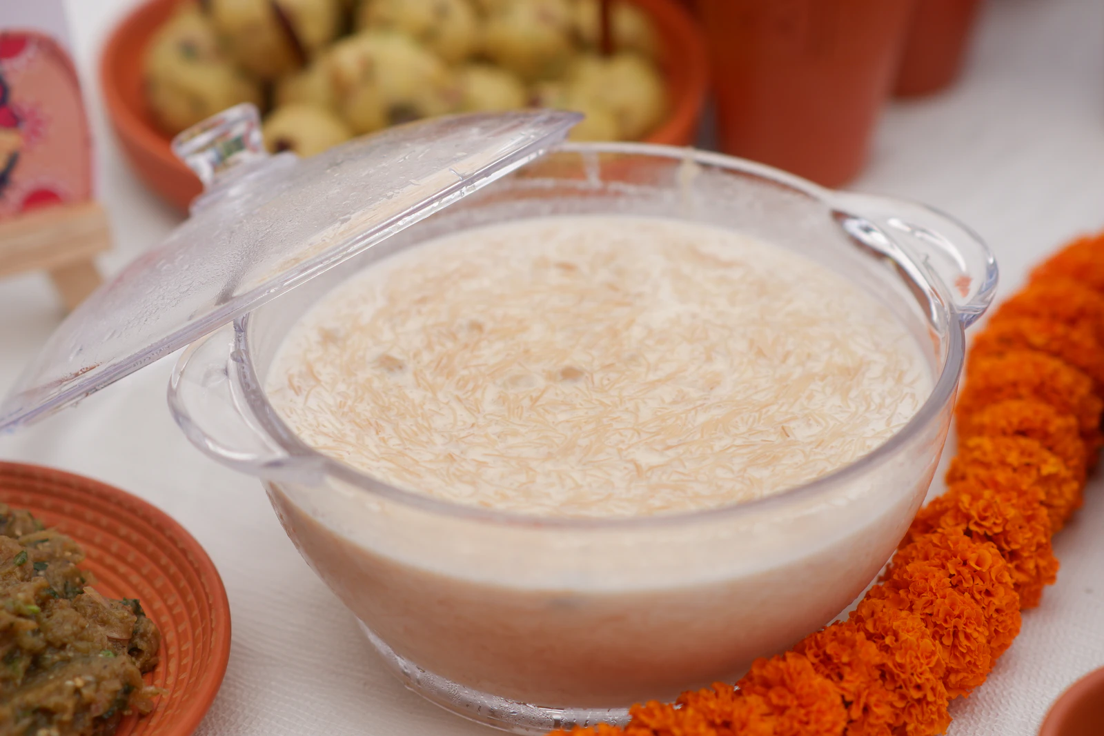 A bowl of creamy rice pudding garnished with flower petals