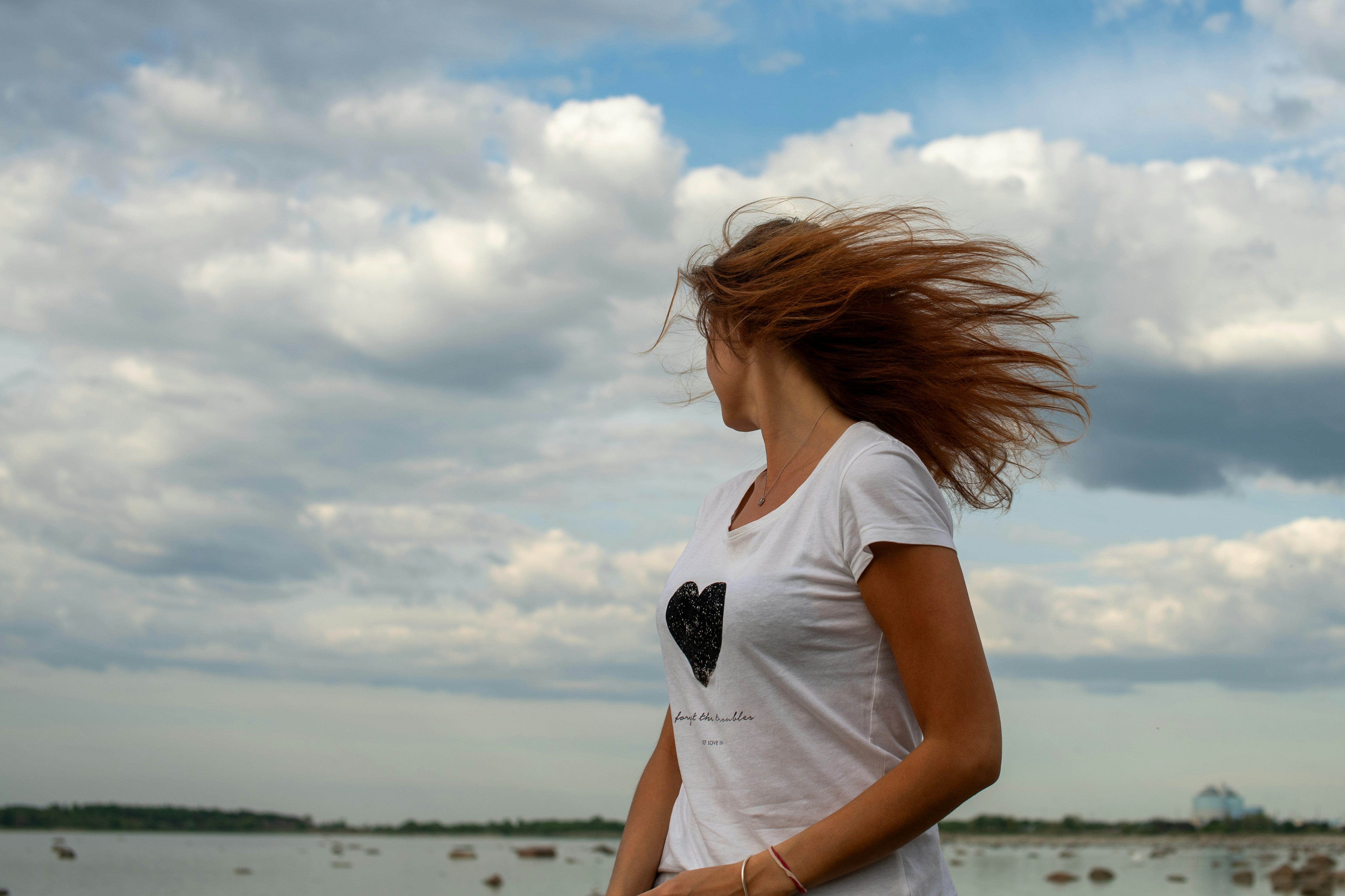 A woman with windblown hair, illustrating how humidity causes frizz