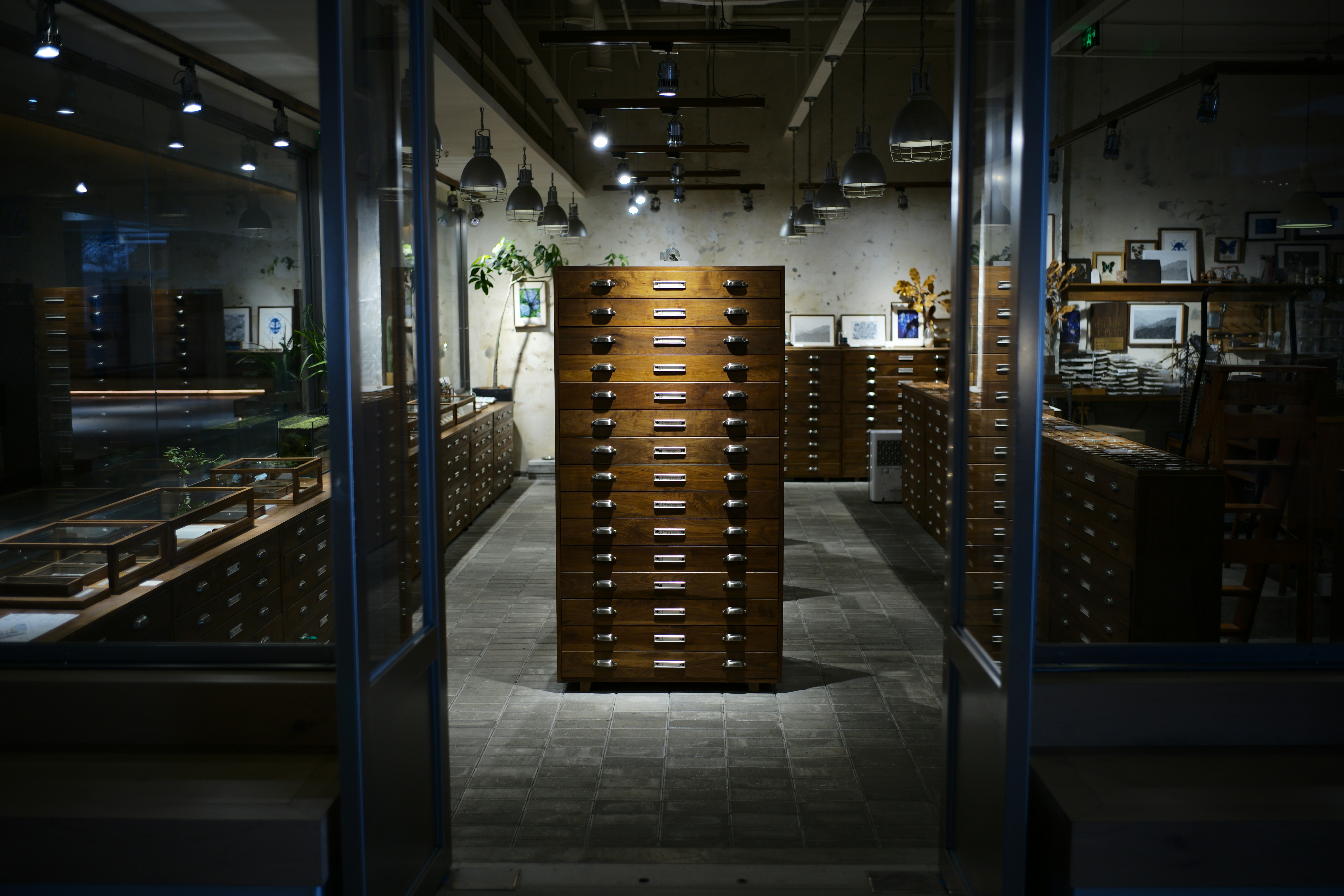 Antique wooden filing cabinets in a dimly lit room.