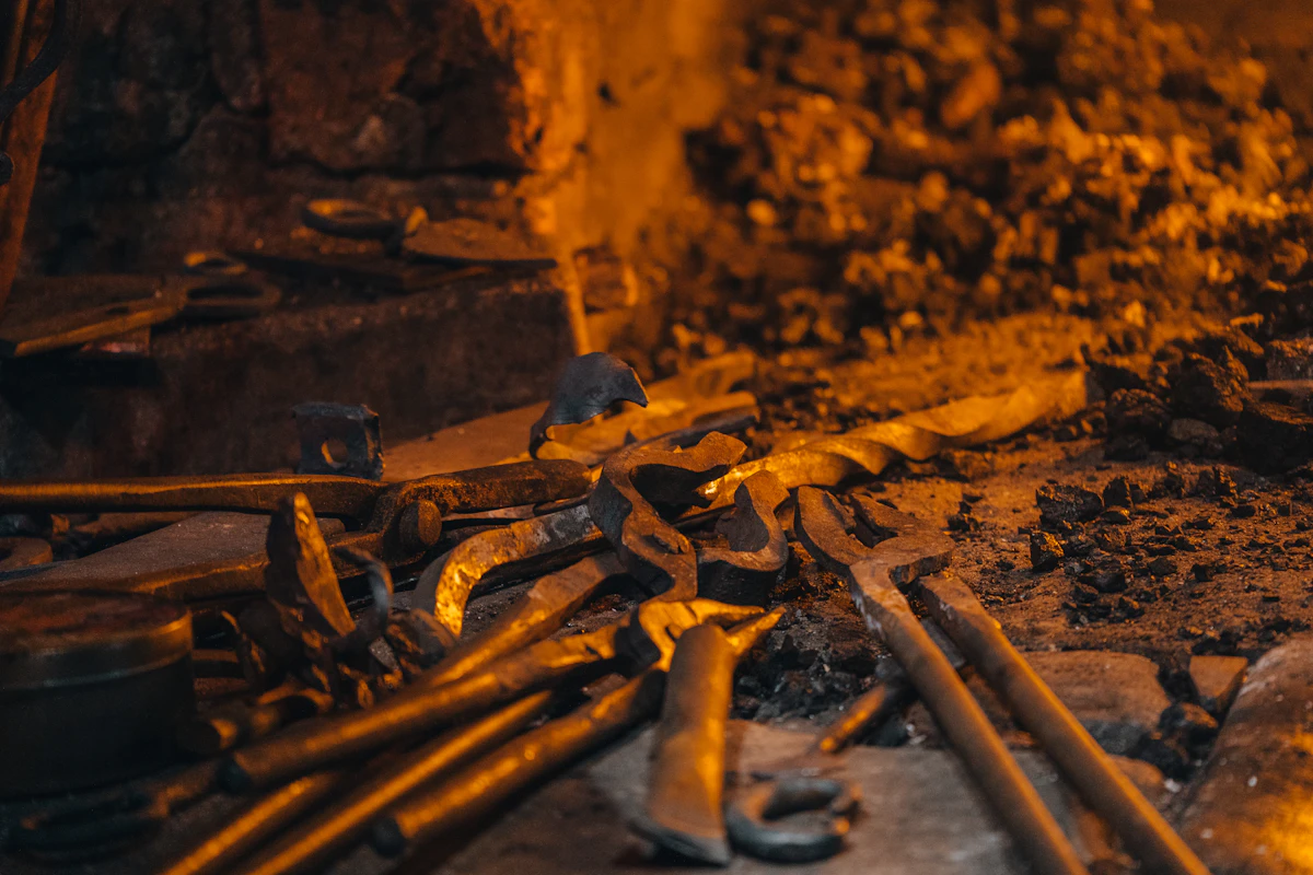 Iron tools resting in a dark forge