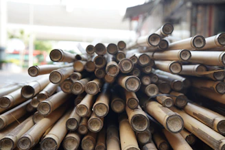 A pile of cut bamboo stalks with open ends.